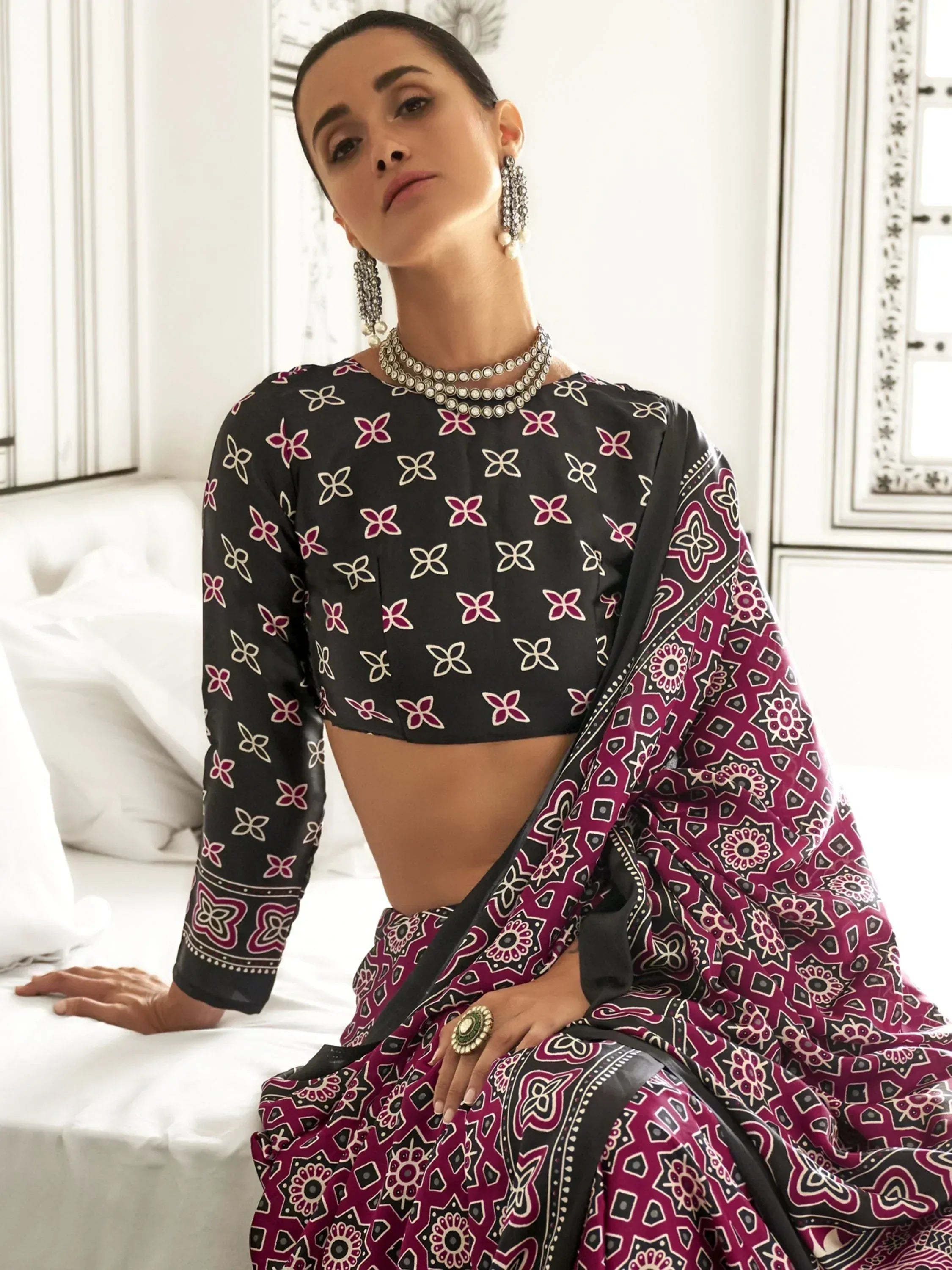 Woman in black and maroon printed saree with floral blouse, traditional Indian ethnic wear