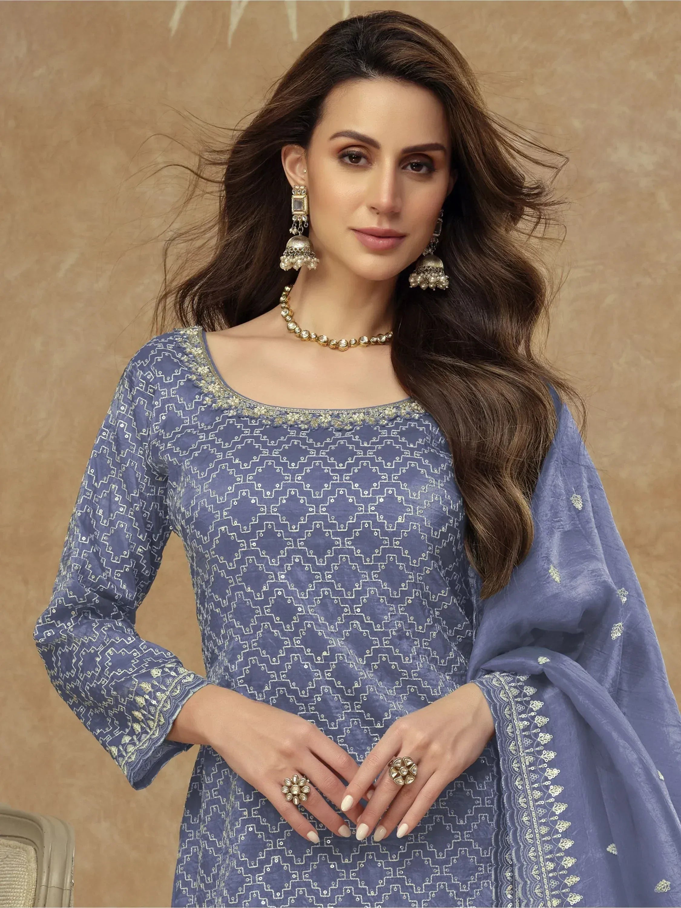 Blue embroidered salwar kameez with geometric print, paired with traditional jewelry for ethnic wear