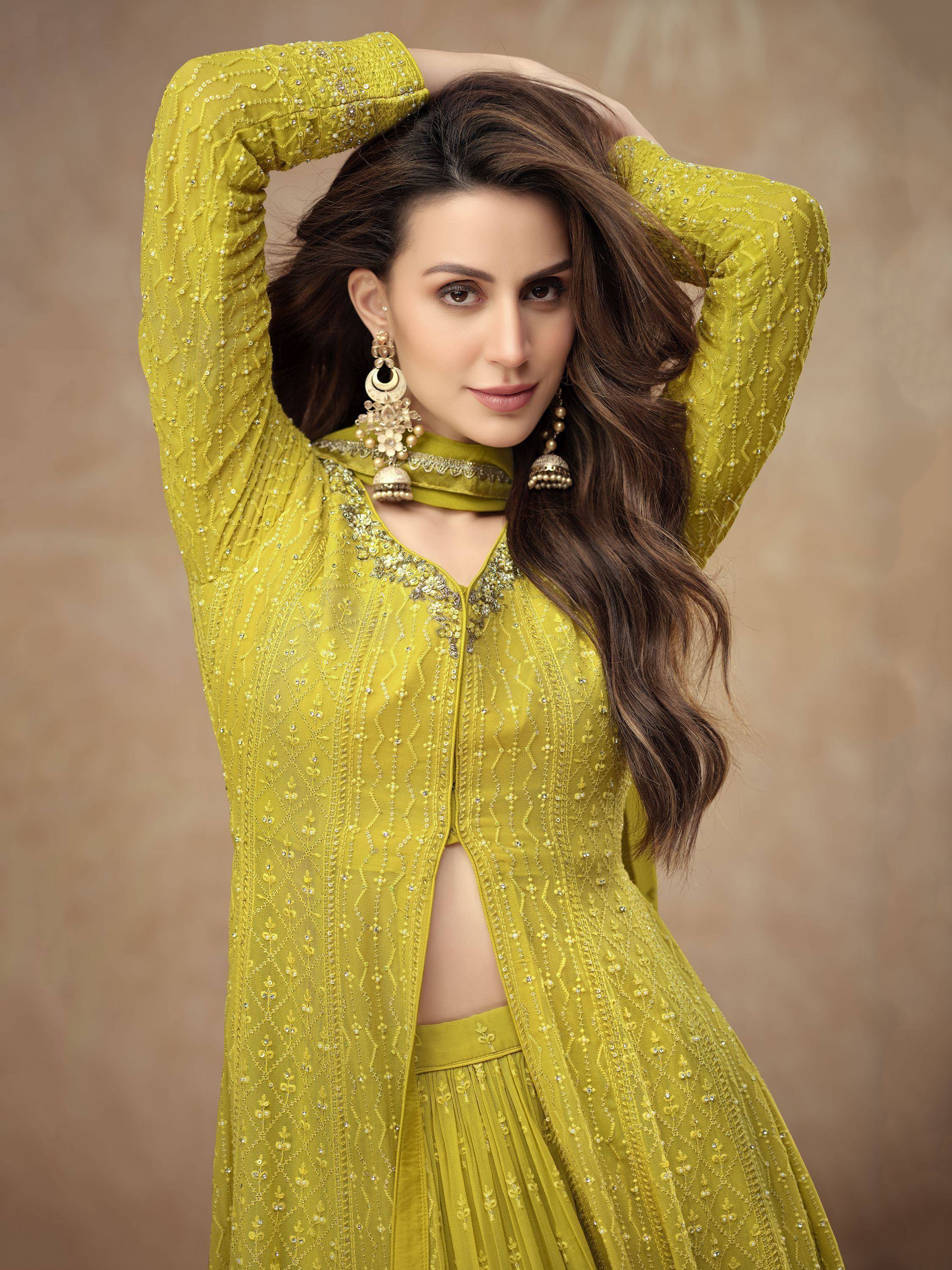 Yellow embroidered Indian ethnic wear with choker and jhumka earrings, perfect for festive occasions.