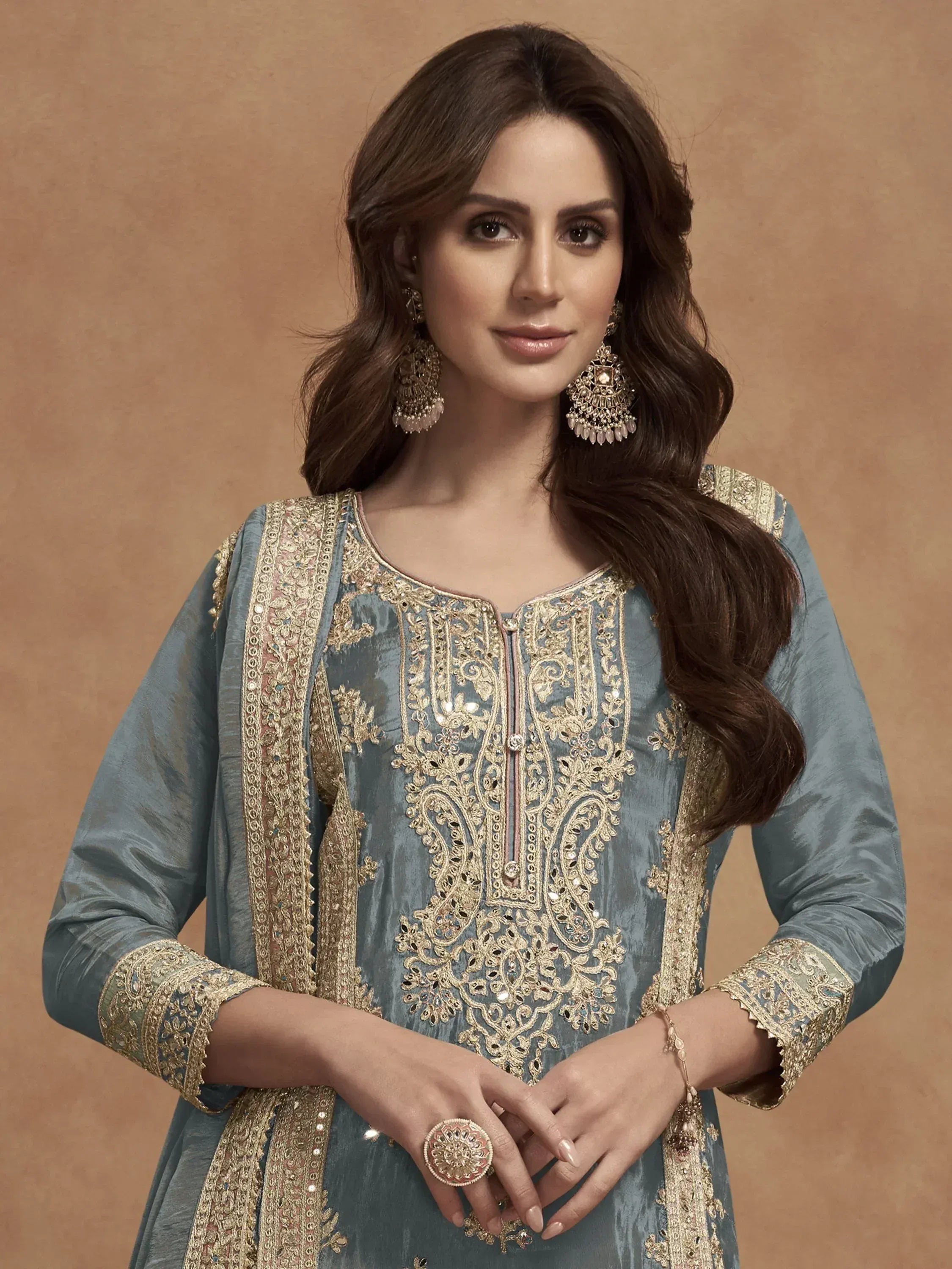 Elegant blue embroidered salwar kameez with gold detailing and traditional jewelry