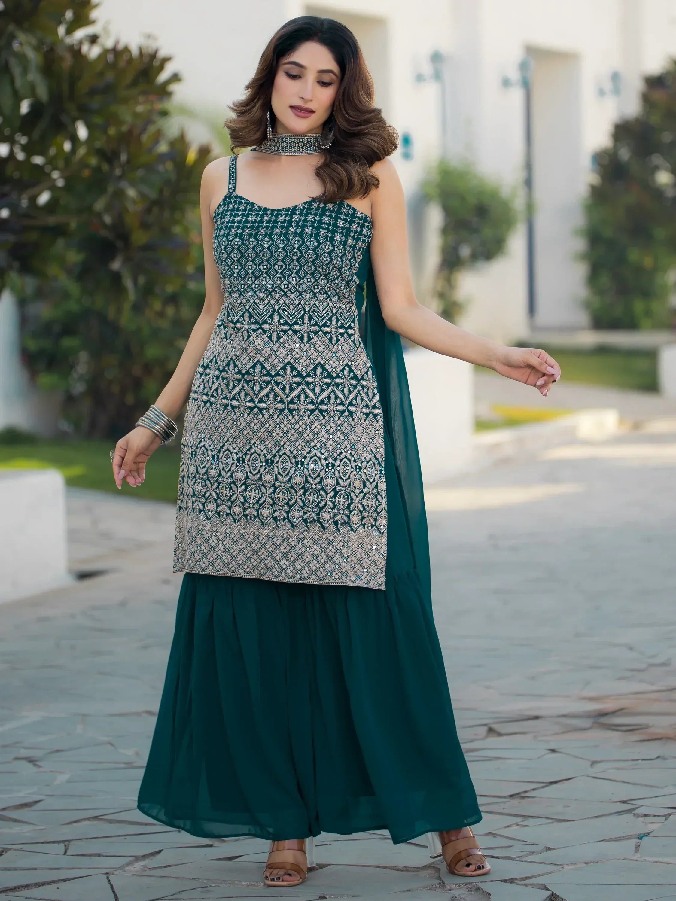 Emerald green embroidered ethnic gown with floral patterns, perfect for Indian festive occasions.