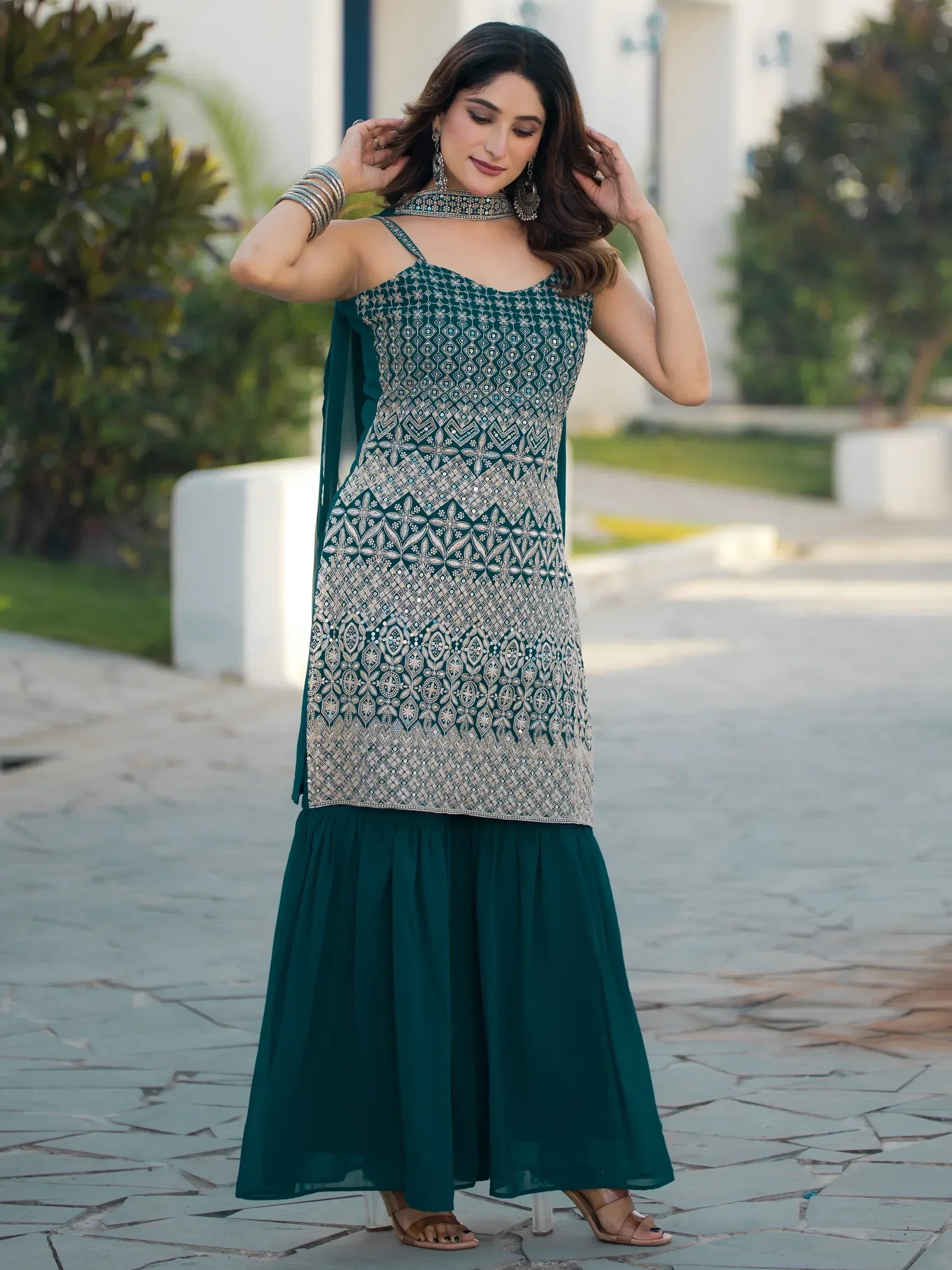 Emerald green embroidered ethnic gown with flared skirt and matching dupatta, perfect for Indian occasions.