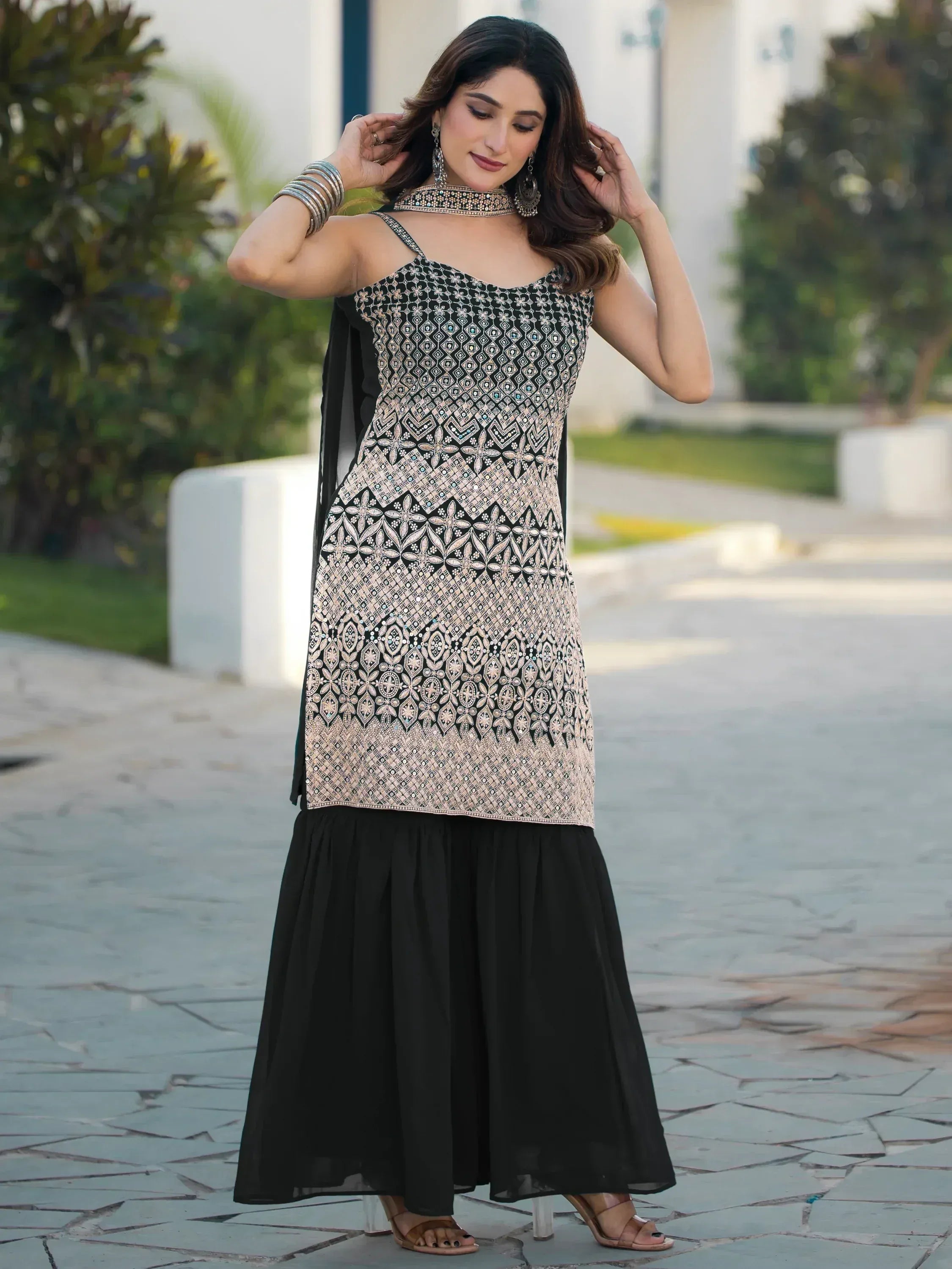 Black and gold embroidered ethnic gown with flared skirt, perfect for Indian festive occasions