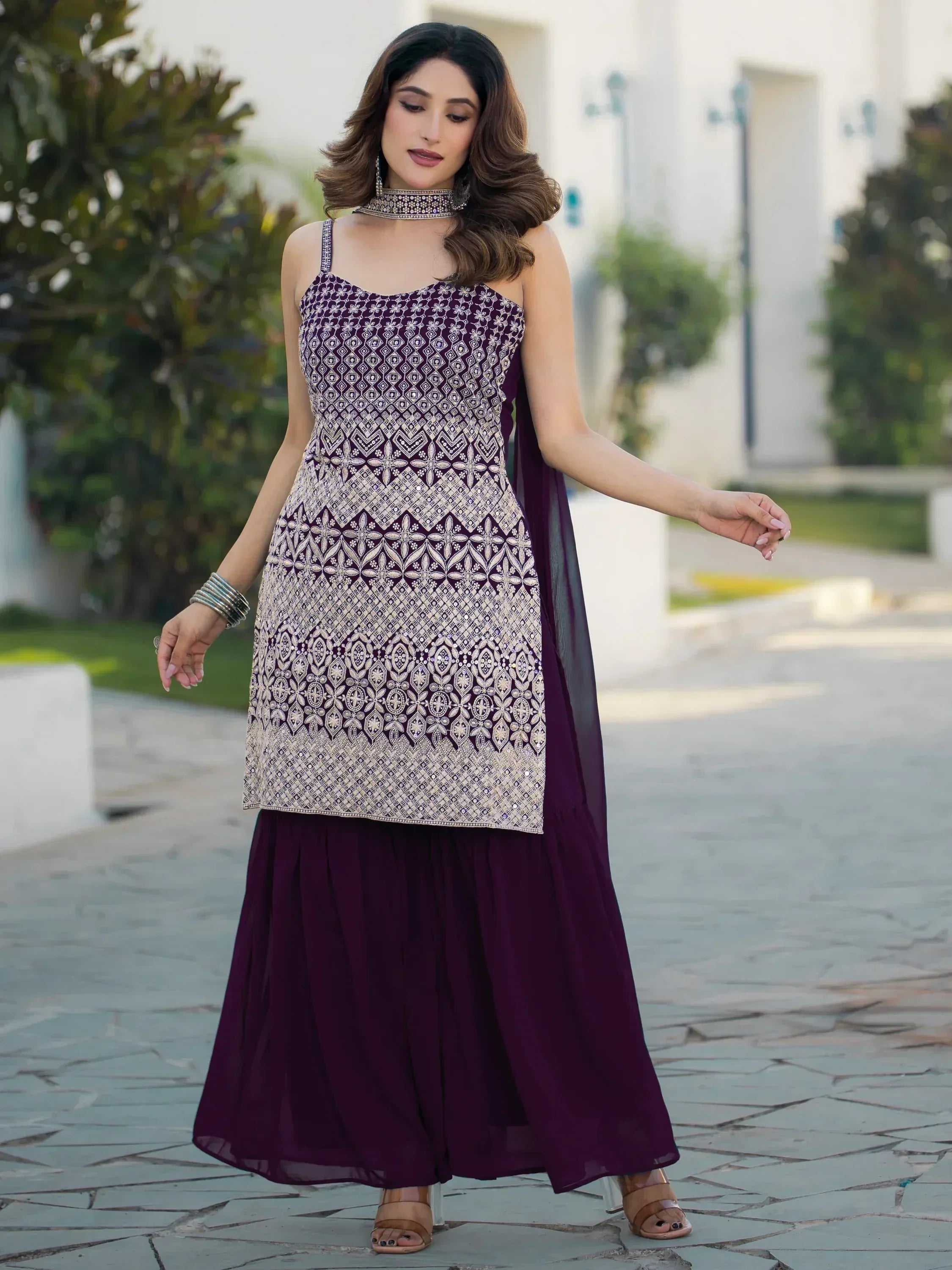 Elegant purple ethnic gown with intricate embroidery and matching dupatta for festive occasions