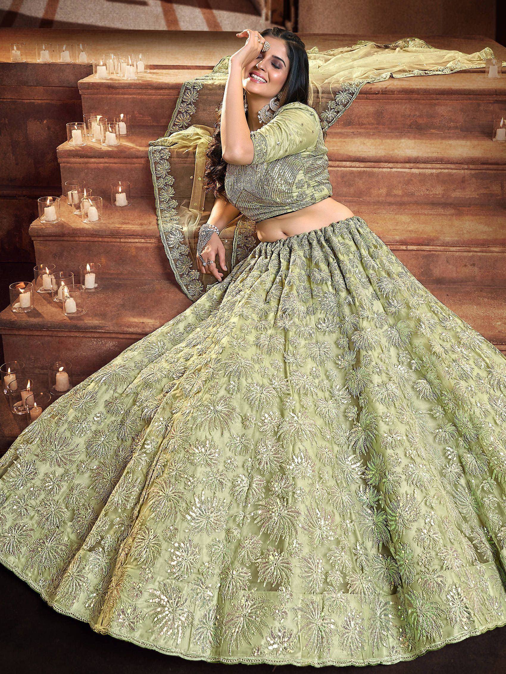 Elegant light green designer lehenga choli with floral embroidery, perfect for weddings and festive occasions.