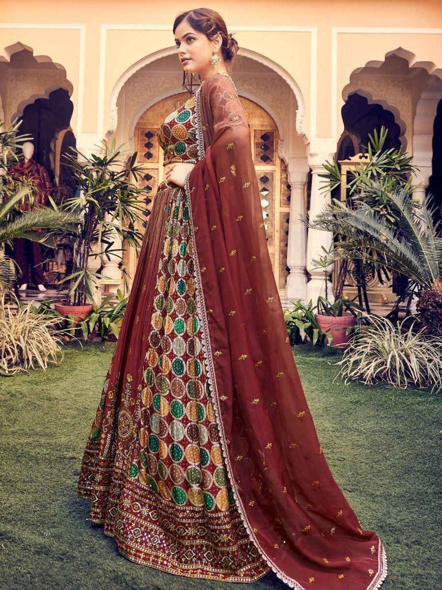 Maroon designer lehenga choli with circular mirror work and gold embroidery, perfect for Indian ethnic occasions