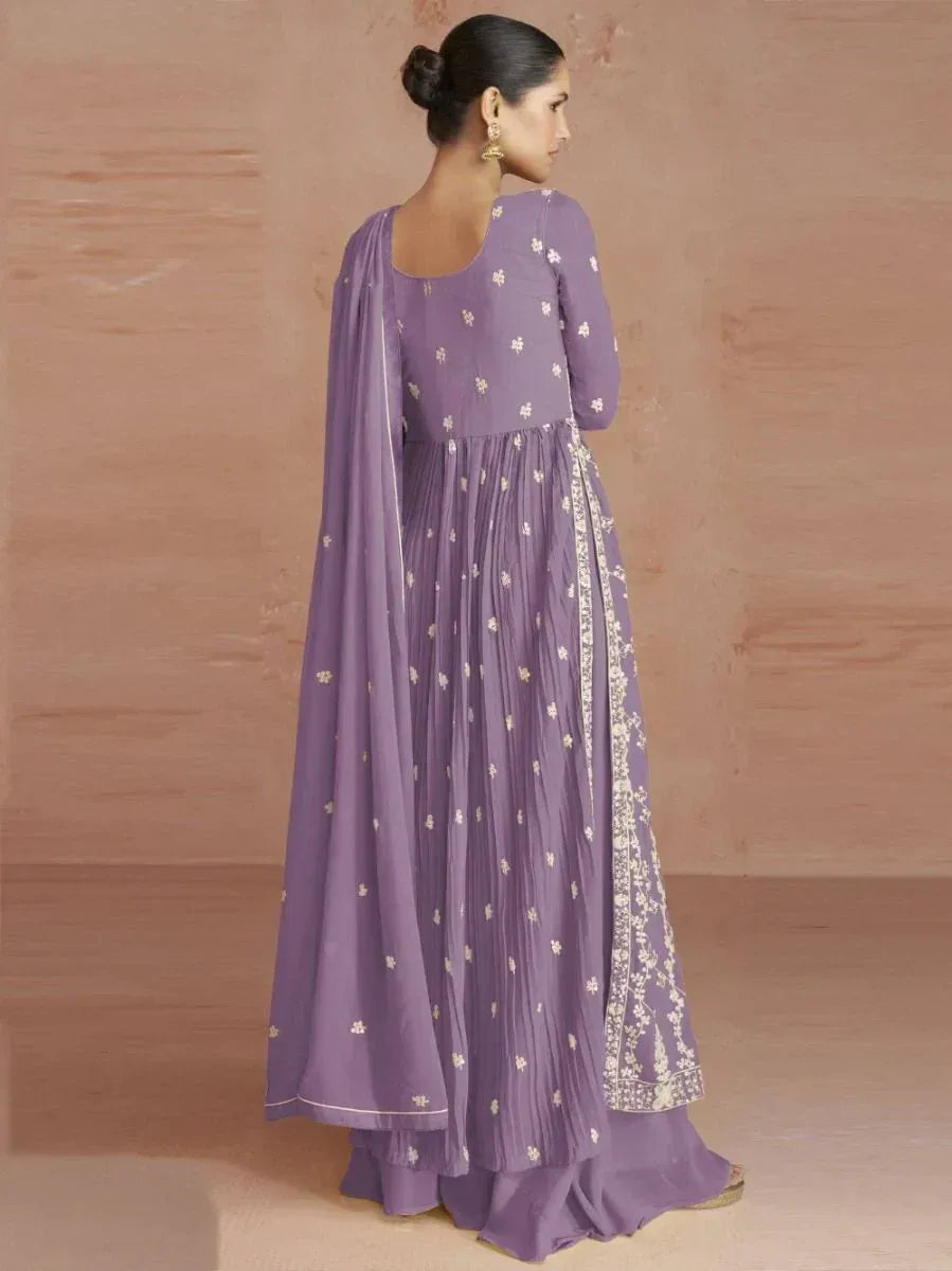Woman in lavender ethnic gown with gold embroidery and dupatta, traditional wear