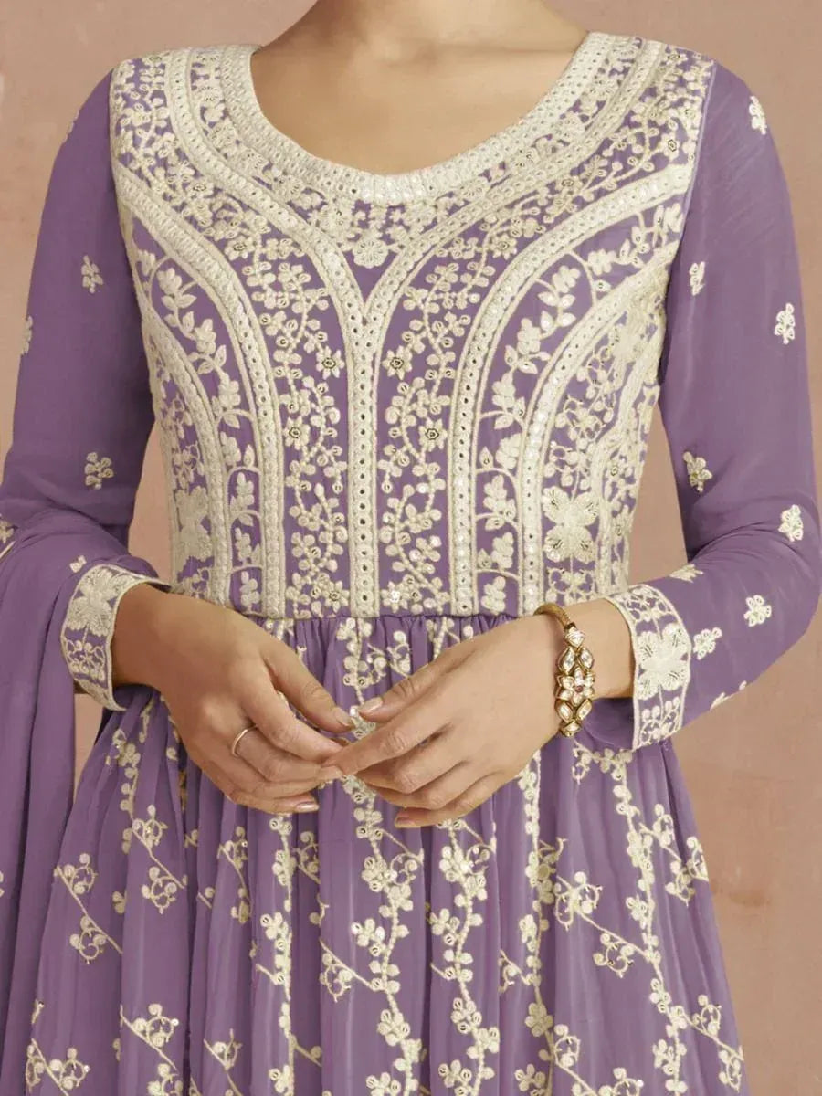 Woman wearing lavender embroidered anarkali gown with floral patterns and full sleeves