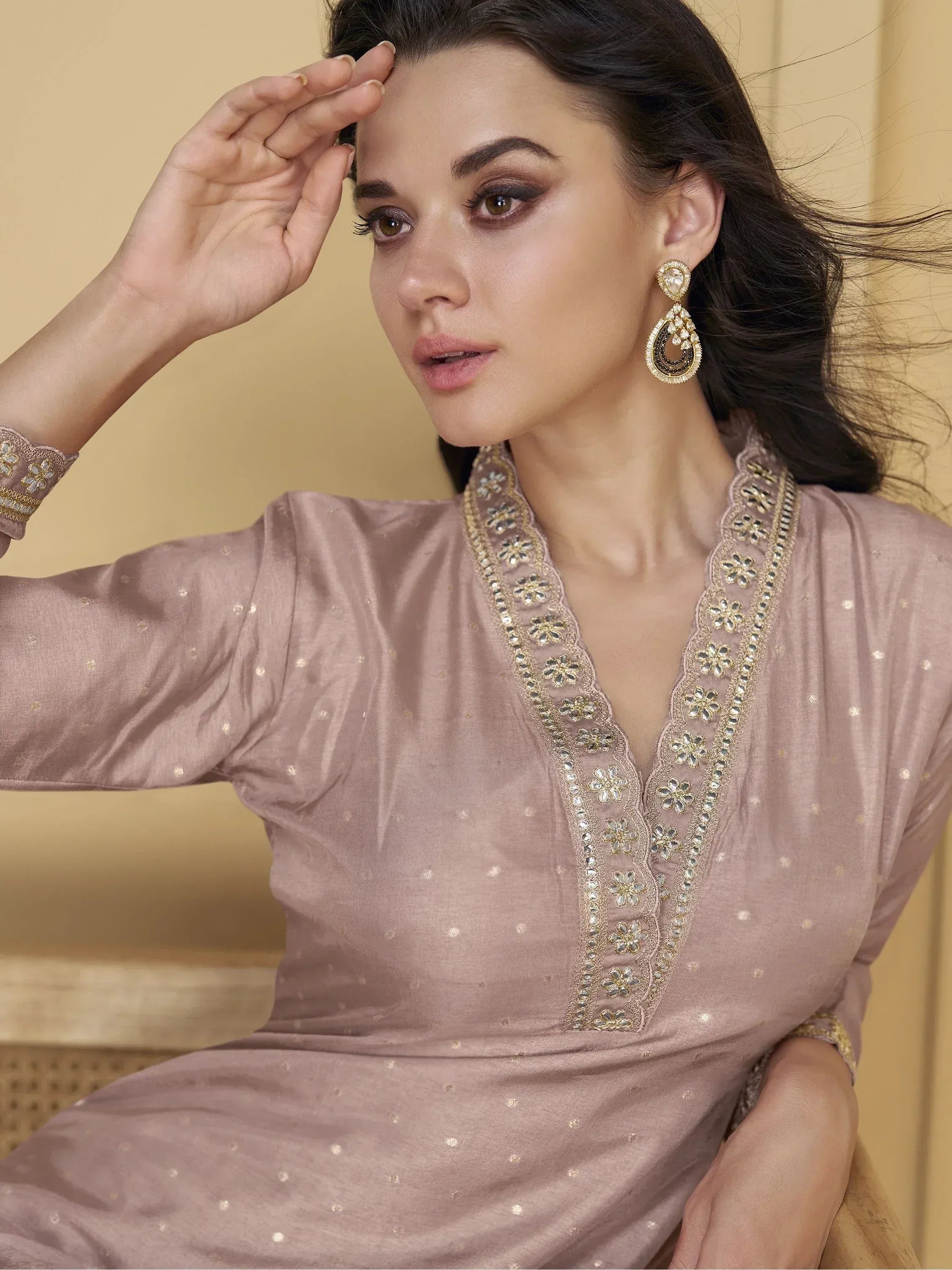 Elegant mauve ethnic gown with gold floral embroidery and matching statement earrings