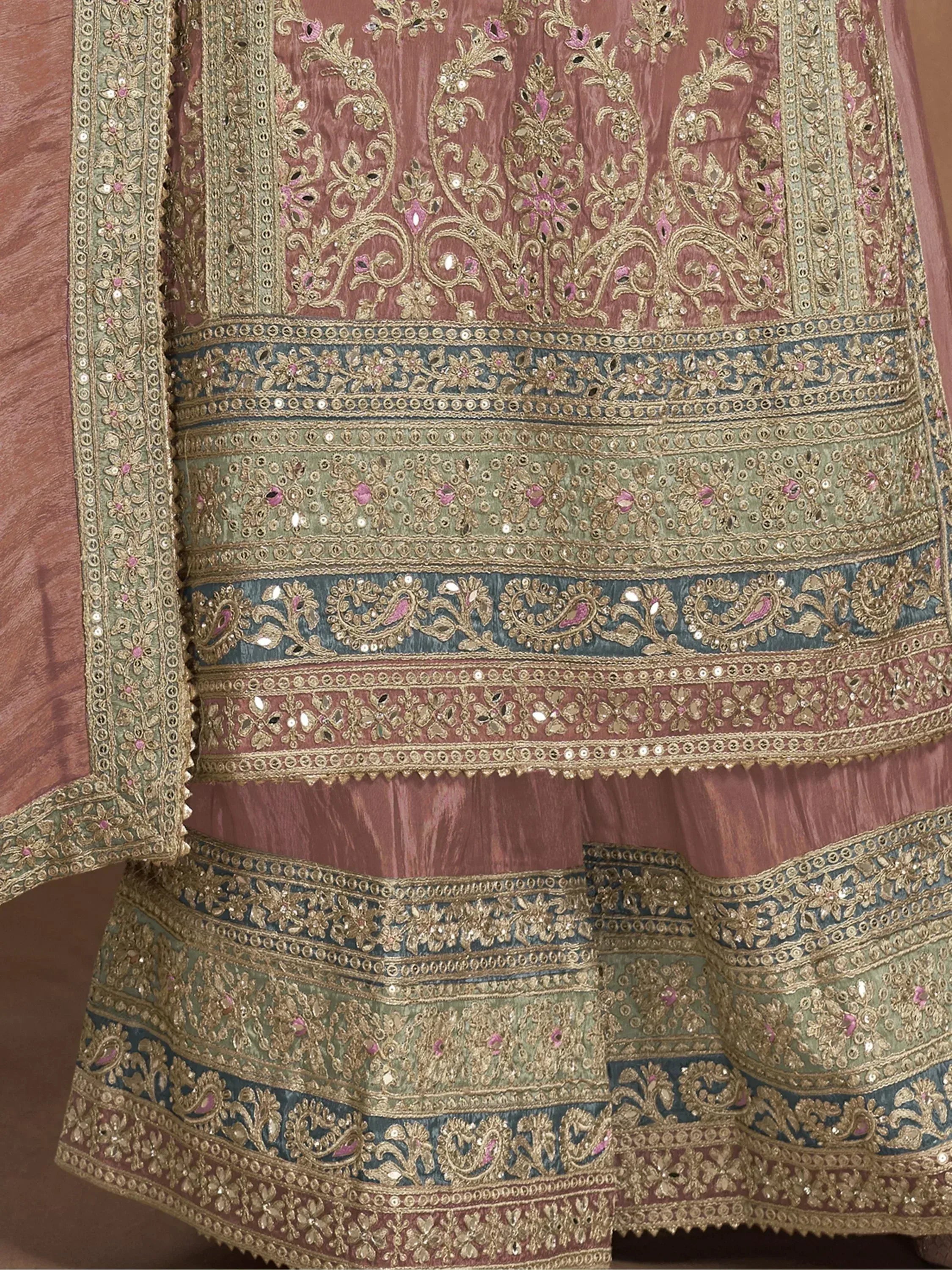 Elegant Indian lehenga choli with intricate gold embroidery, floral motifs, and mirror work in pink, green, and blue hues.