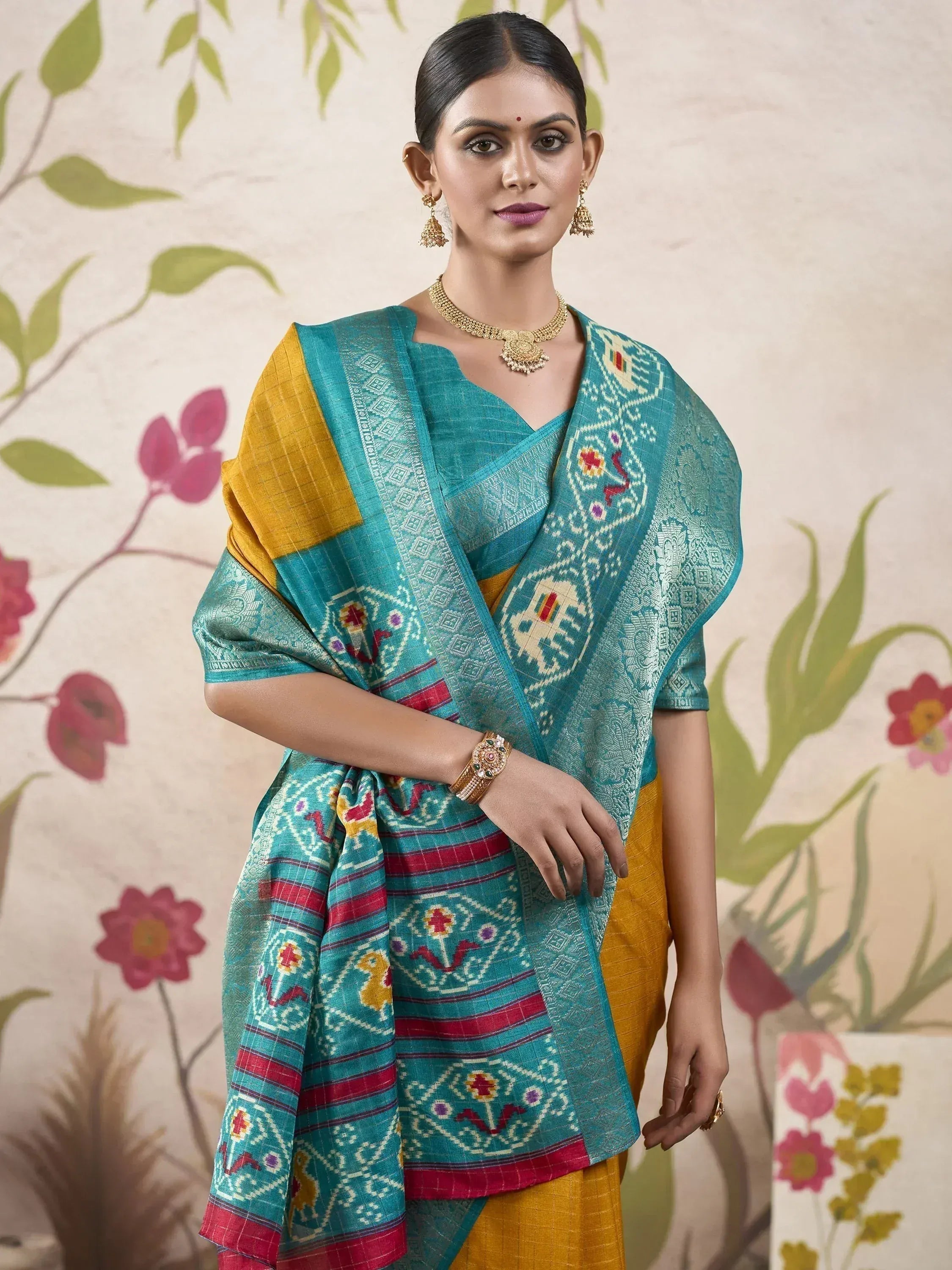 Teal and mustard ethnic saree with intricate tribal print, perfect for Indian occasions