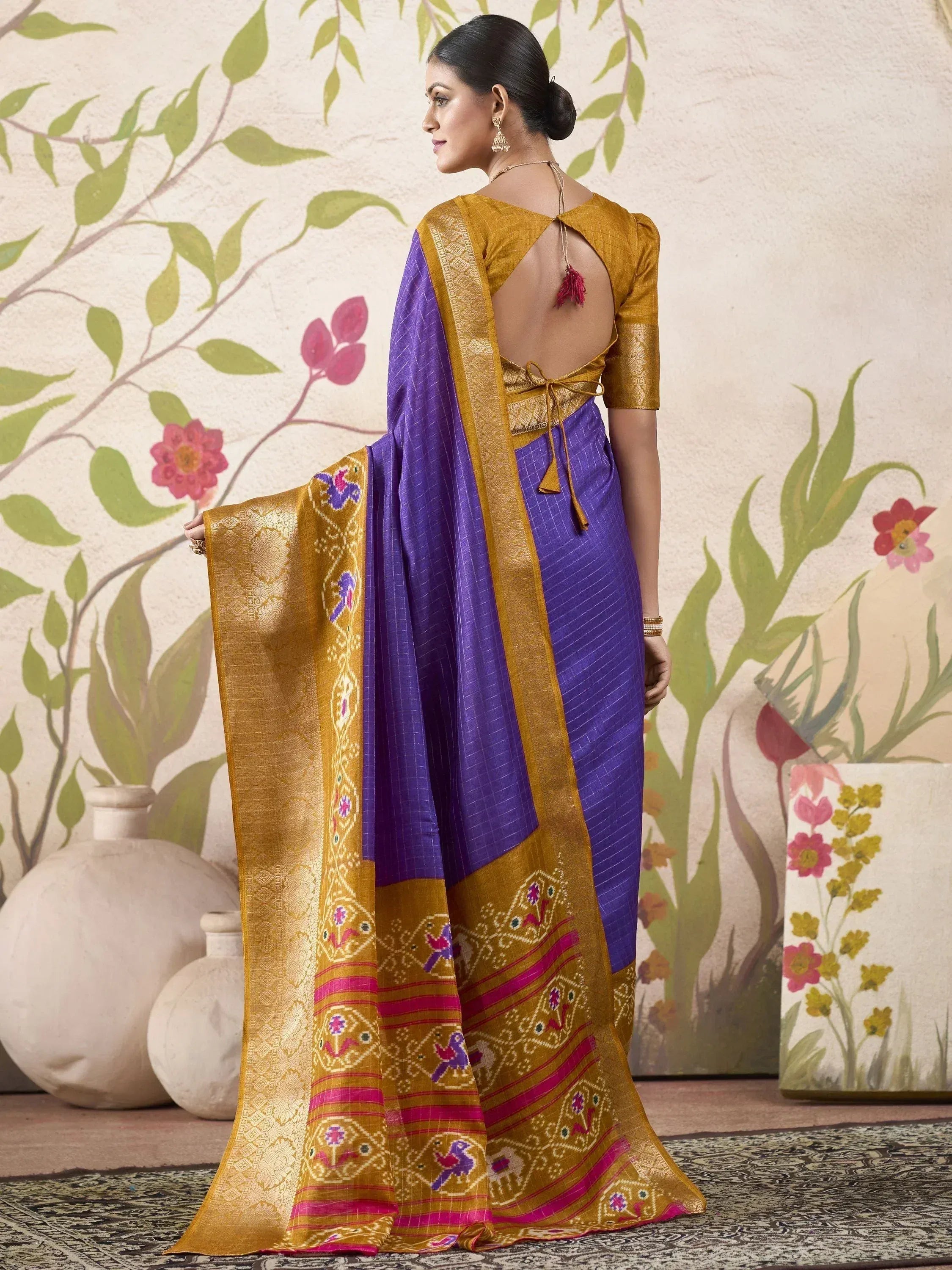 Purple and gold designer saree with embroidered border and backless blouse, perfect for ethnic occasions
