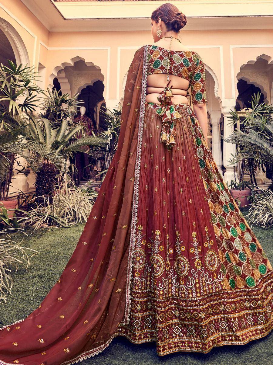 Maroon embroidered lehenga choli with circular motifs, back view in courtyard setting