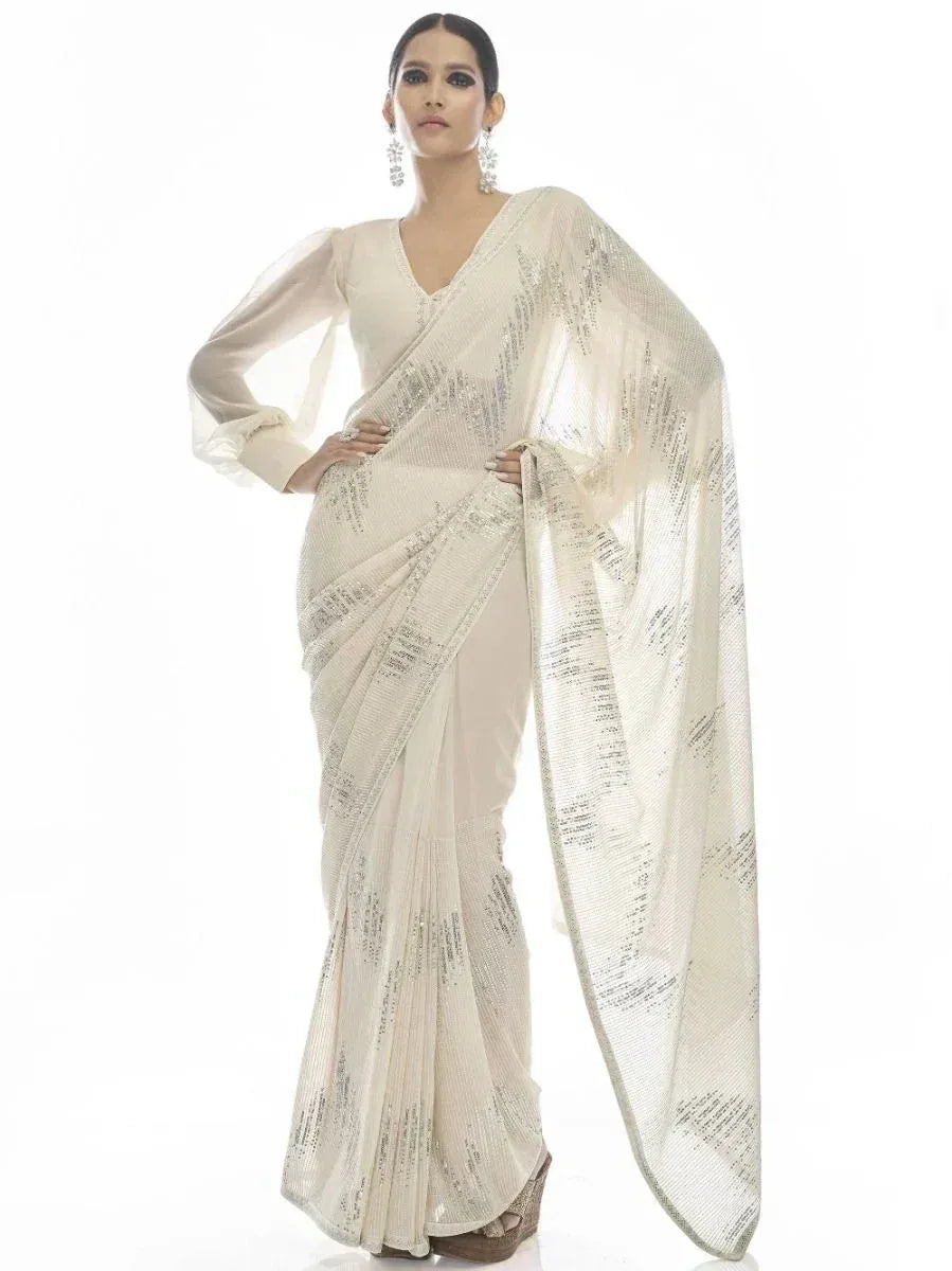 Elegant ivory saree with silver sequin work, paired with matching blouse for Indian ethnic wear