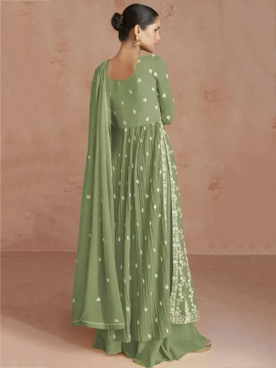 Woman wearing sage green embroidered Anarkali suit with dupatta, back view