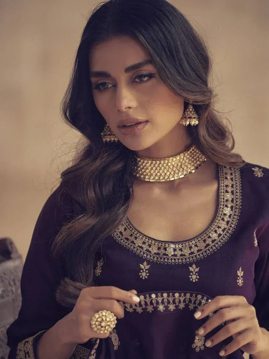 Elegant Indian ethnic wear with gold embroidery, choker, and jhumka earrings for festive occasions