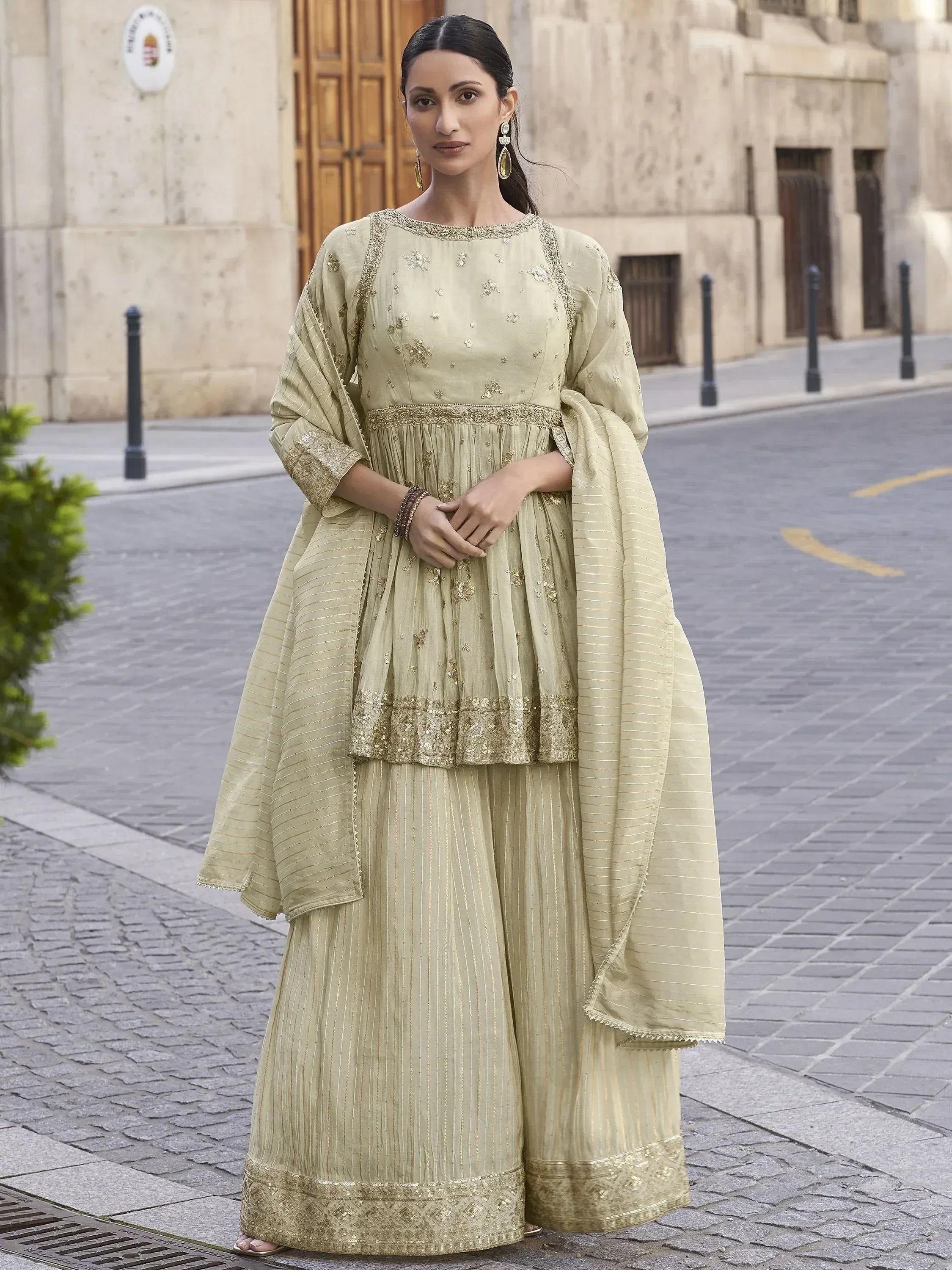 Elegant light green embroidered sharara suit with gold detailing, perfect for Indian ethnic occasions