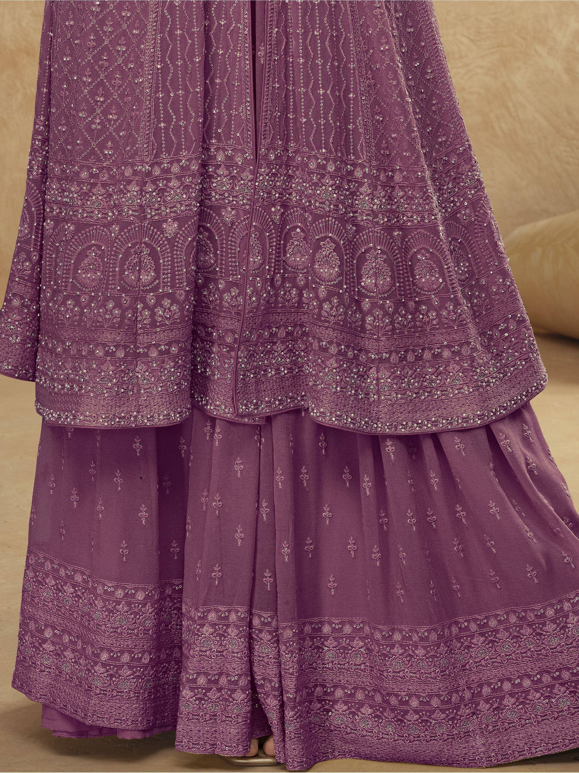 Purple embroidered lehenga choli with intricate floral patterns and embellished borders, perfect for Indian ethnic wear.