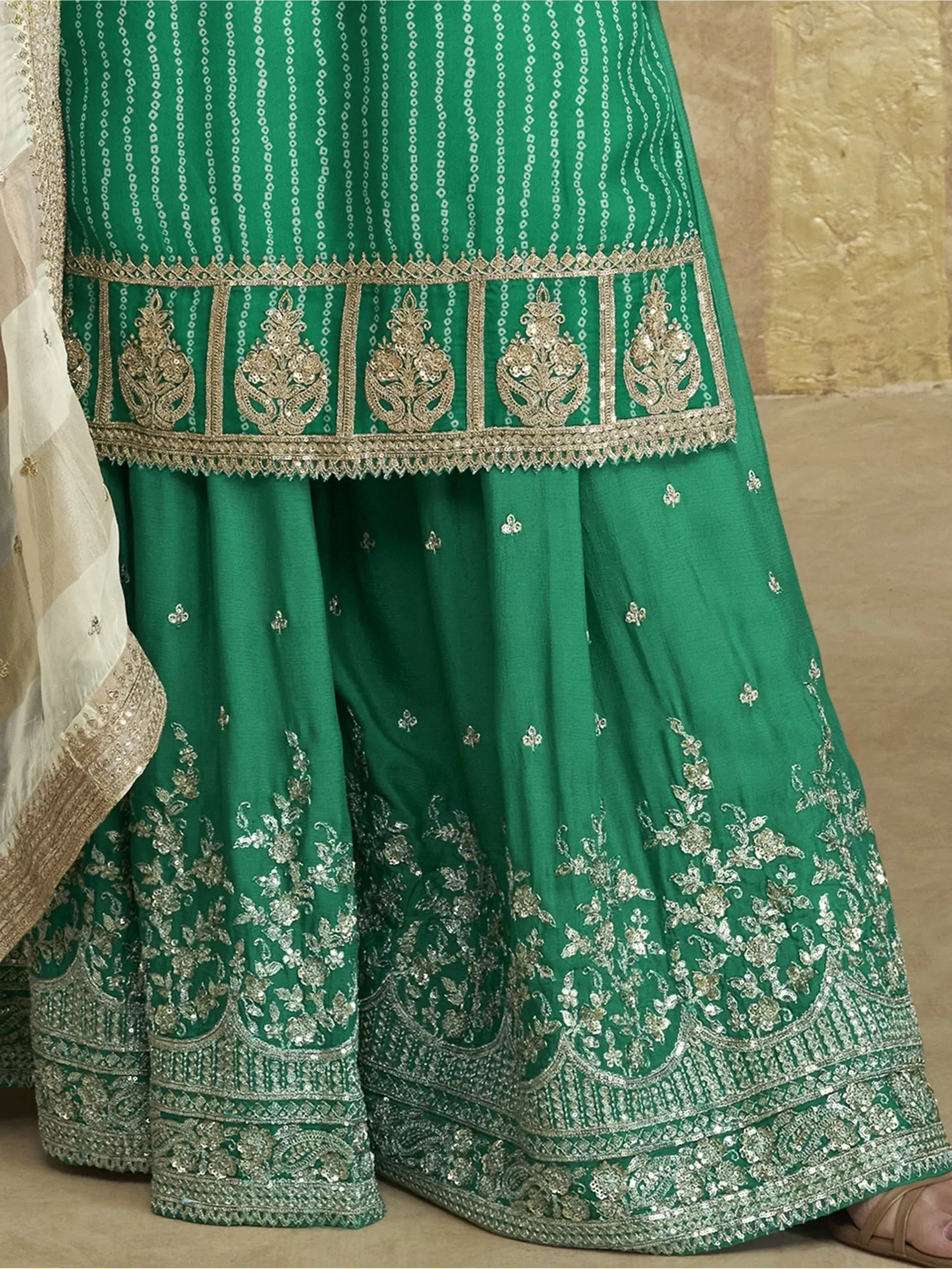 Emerald green designer lehenga with gold embroidery and floral motifs, perfect for Indian ethnic wear occasions.