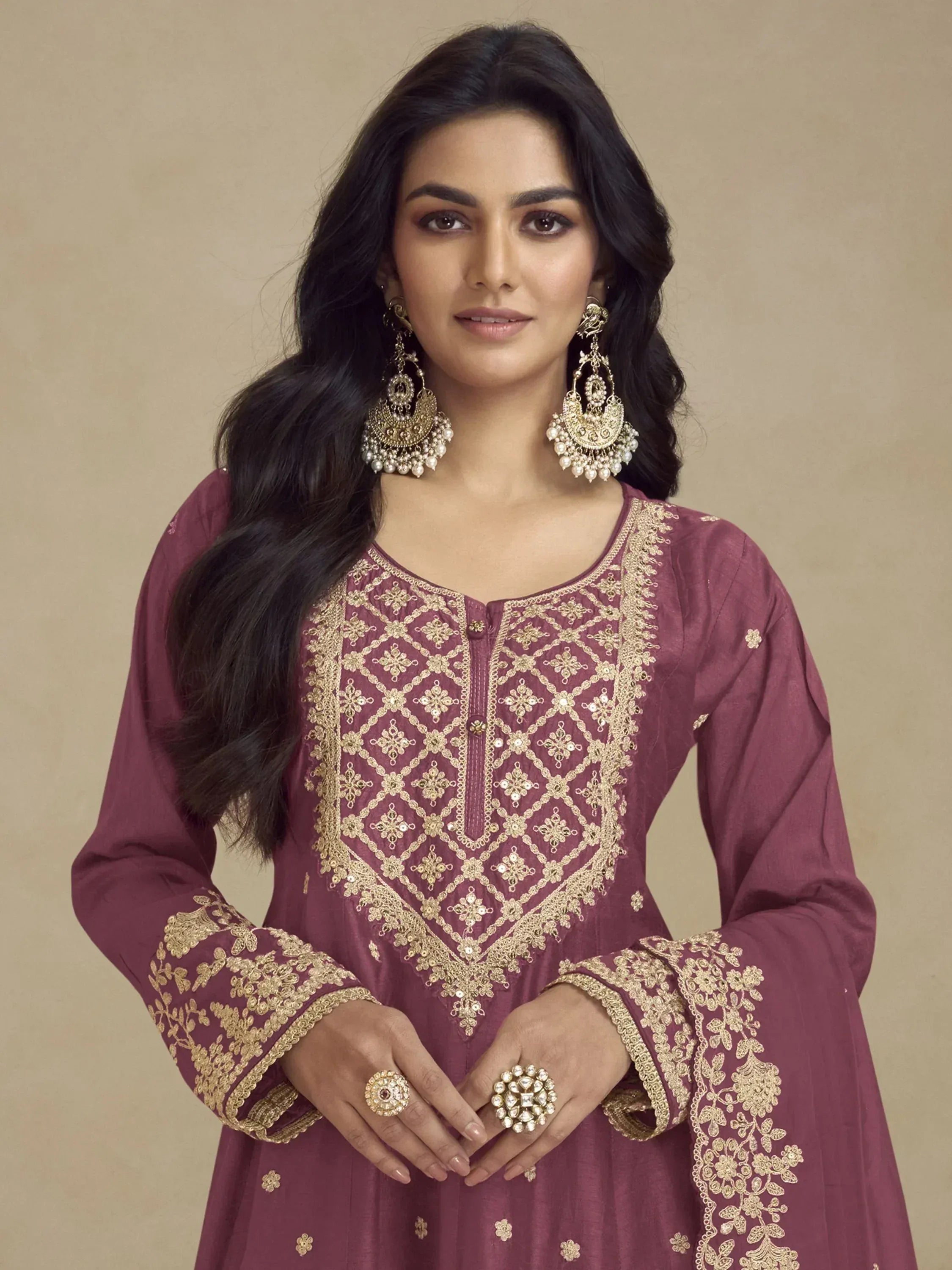 Maroon ethnic kurti with gold embroidery, paired with statement earrings and rings for festive occasions