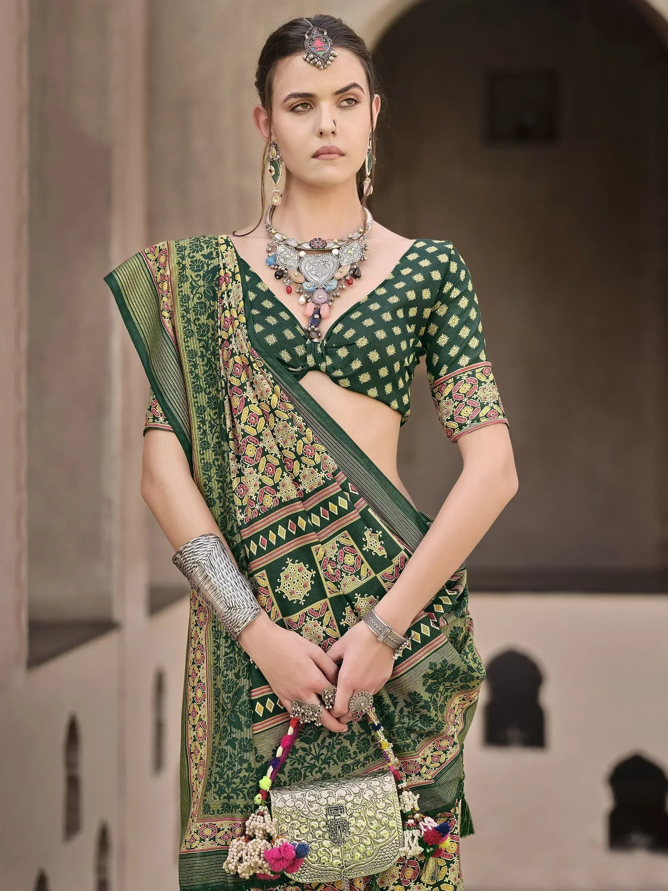 Green printed saree with blouse, traditional jewelry, and ethnic accessories for Indian wear