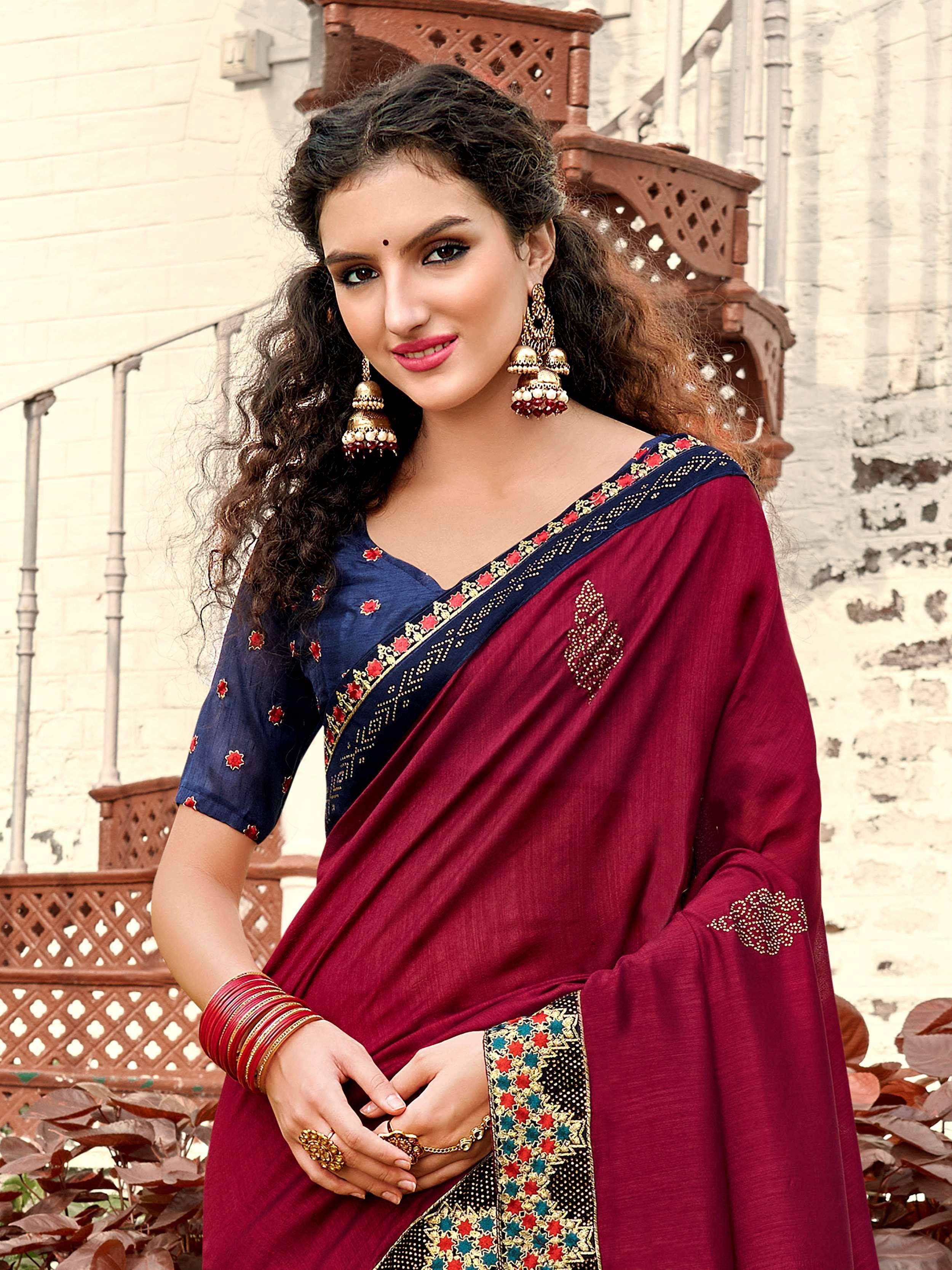Maroon and navy blue embroidered saree with traditional Indian jewelry for festive occasions