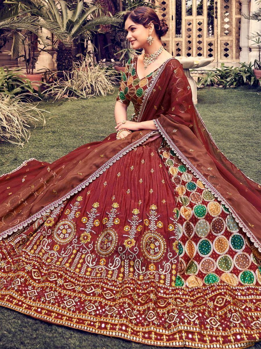 Maroon designer lehenga choli with colorful mirror work and floral embroidery, perfect for Indian weddings.