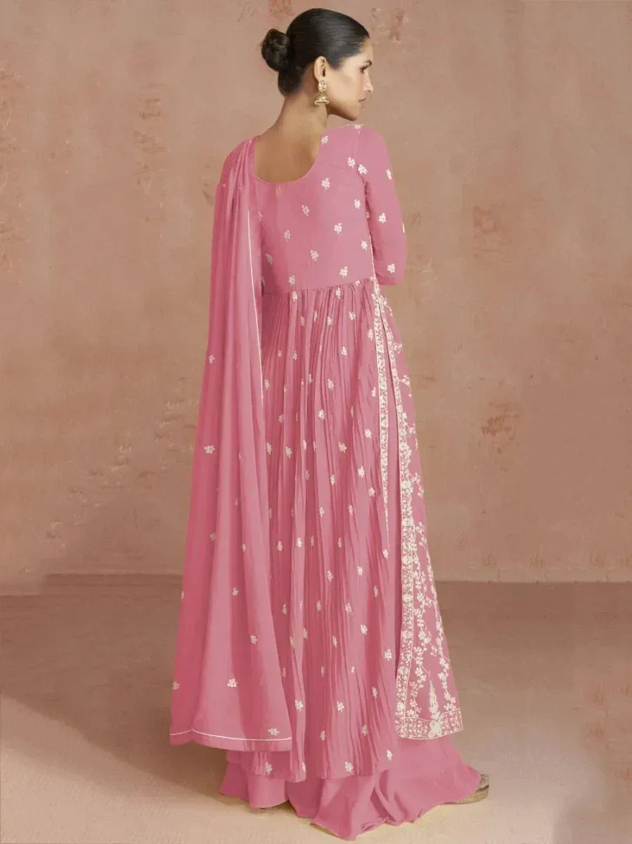 Woman wearing pink embroidered Anarkali suit with dupatta, side view, ethnic fashion