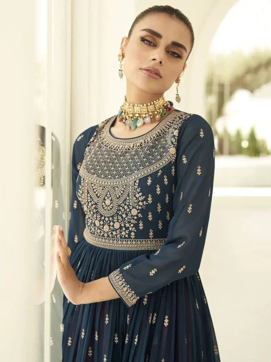 Woman in blue embroidered ethnic gown with gold jewelry and statement choker necklace