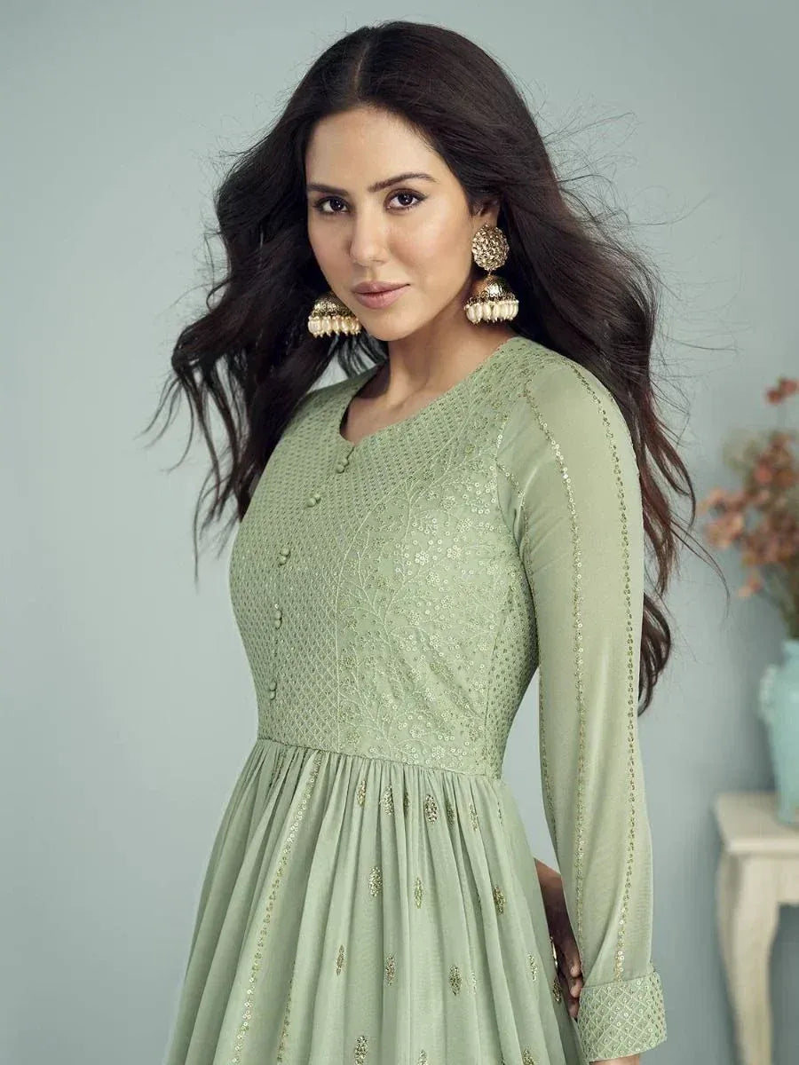 Mint green embroidered ethnic gown with gold detailing, perfect for Indian occasions and festive wear.