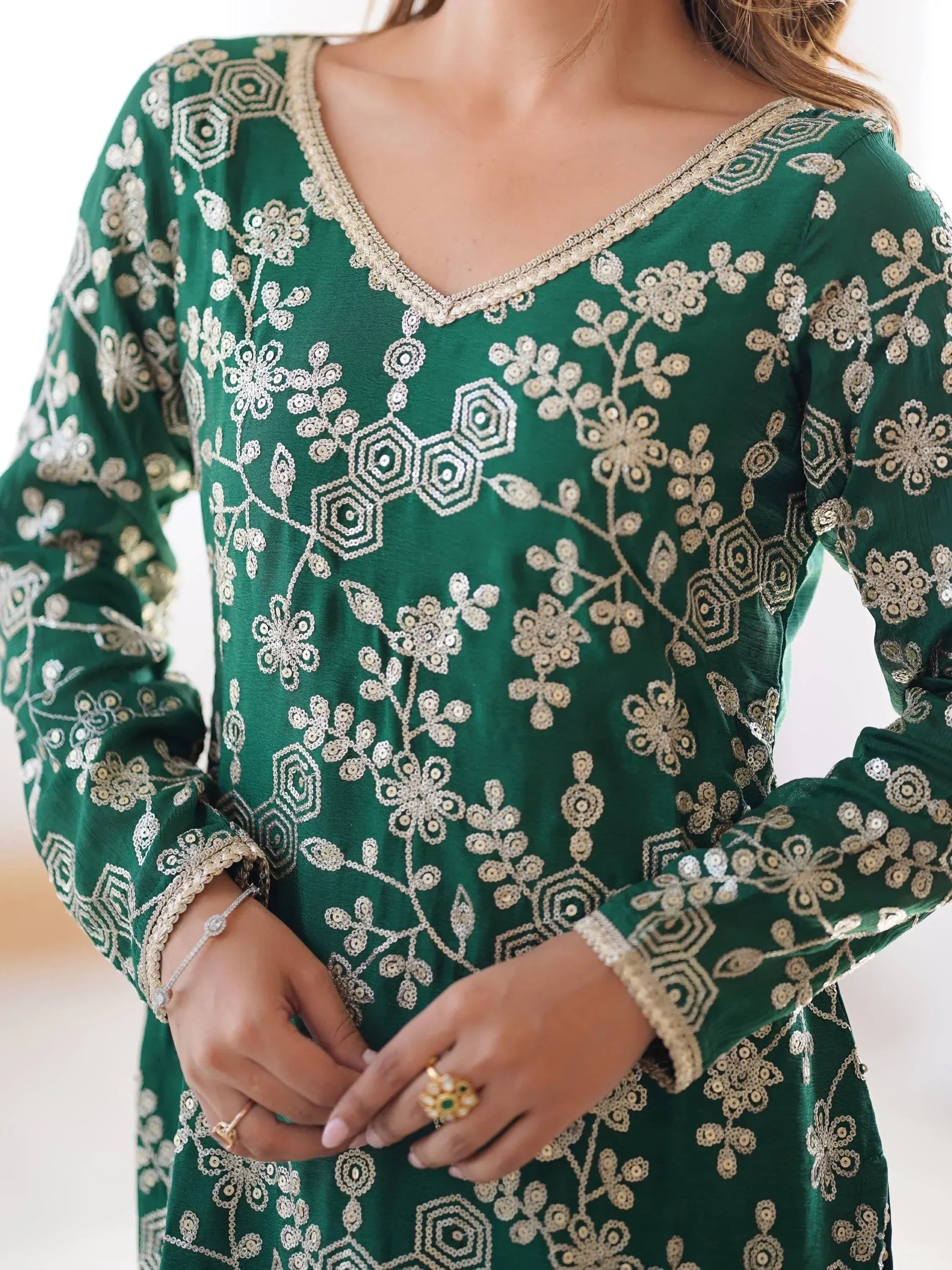 Emerald green ethnic kurti with floral embroidery and gold detailing, perfect for festive occasions.