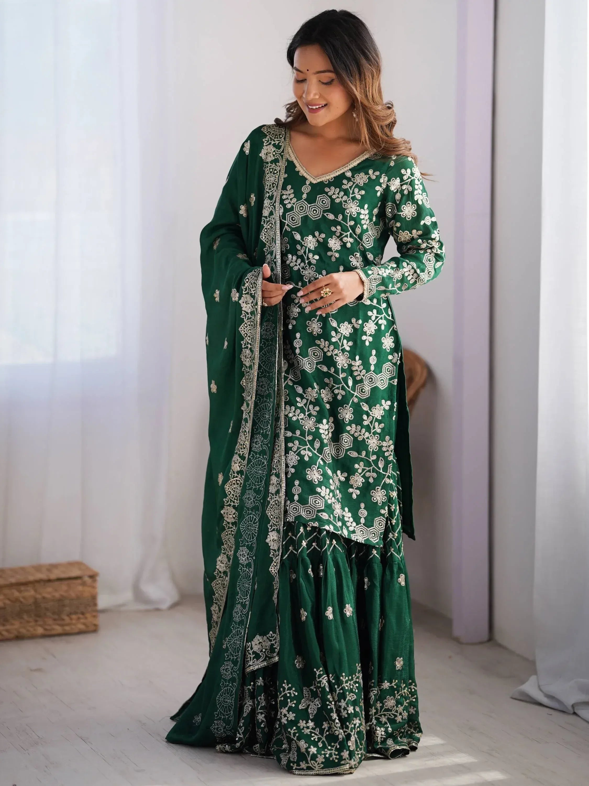 Emerald green embroidered salwar kameez with floral motifs, perfect for Indian ethnic wear occasions.