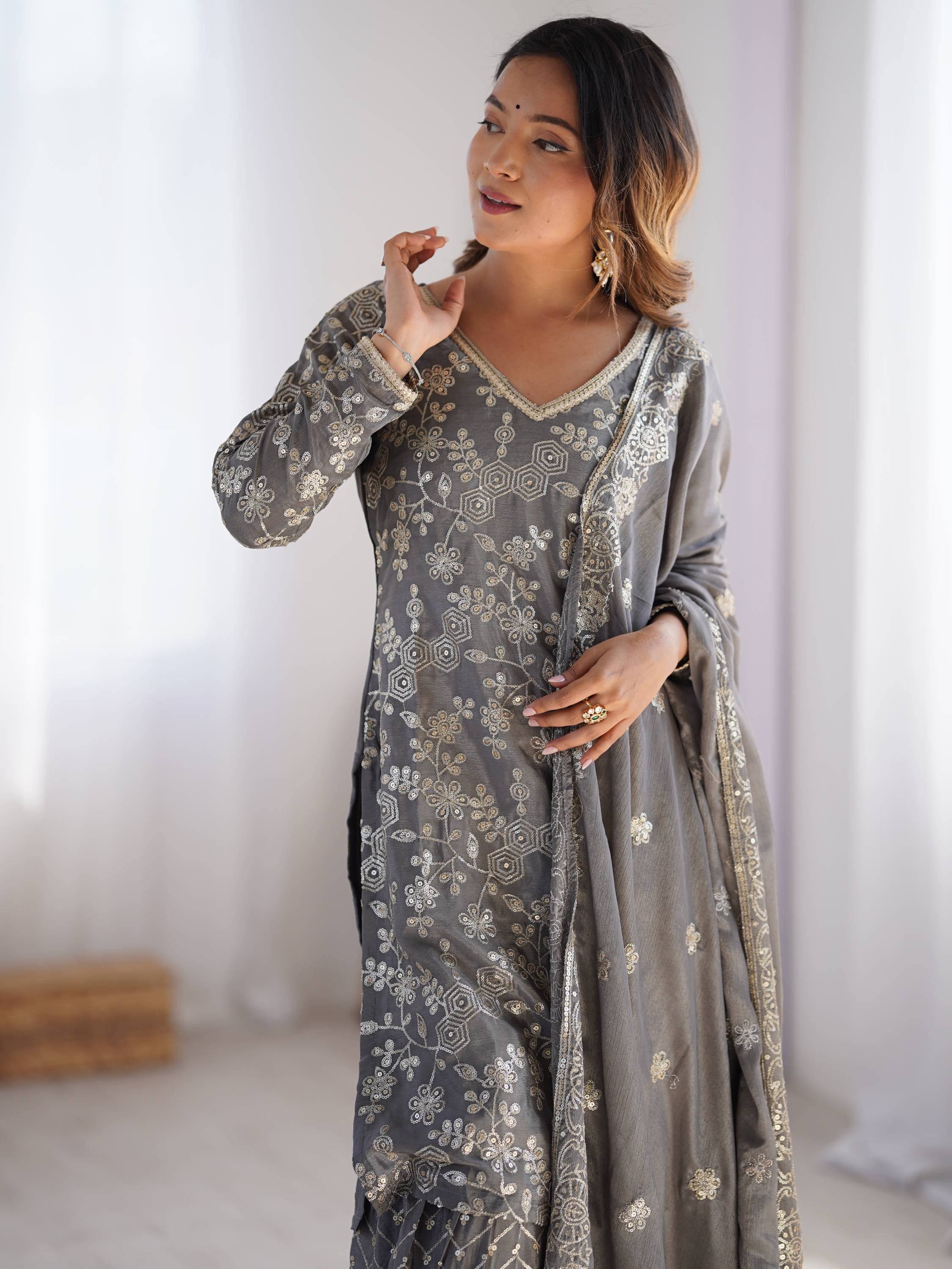Grey embroidered salwar kameez with gold floral work, perfect for Indian ethnic wear occasions.