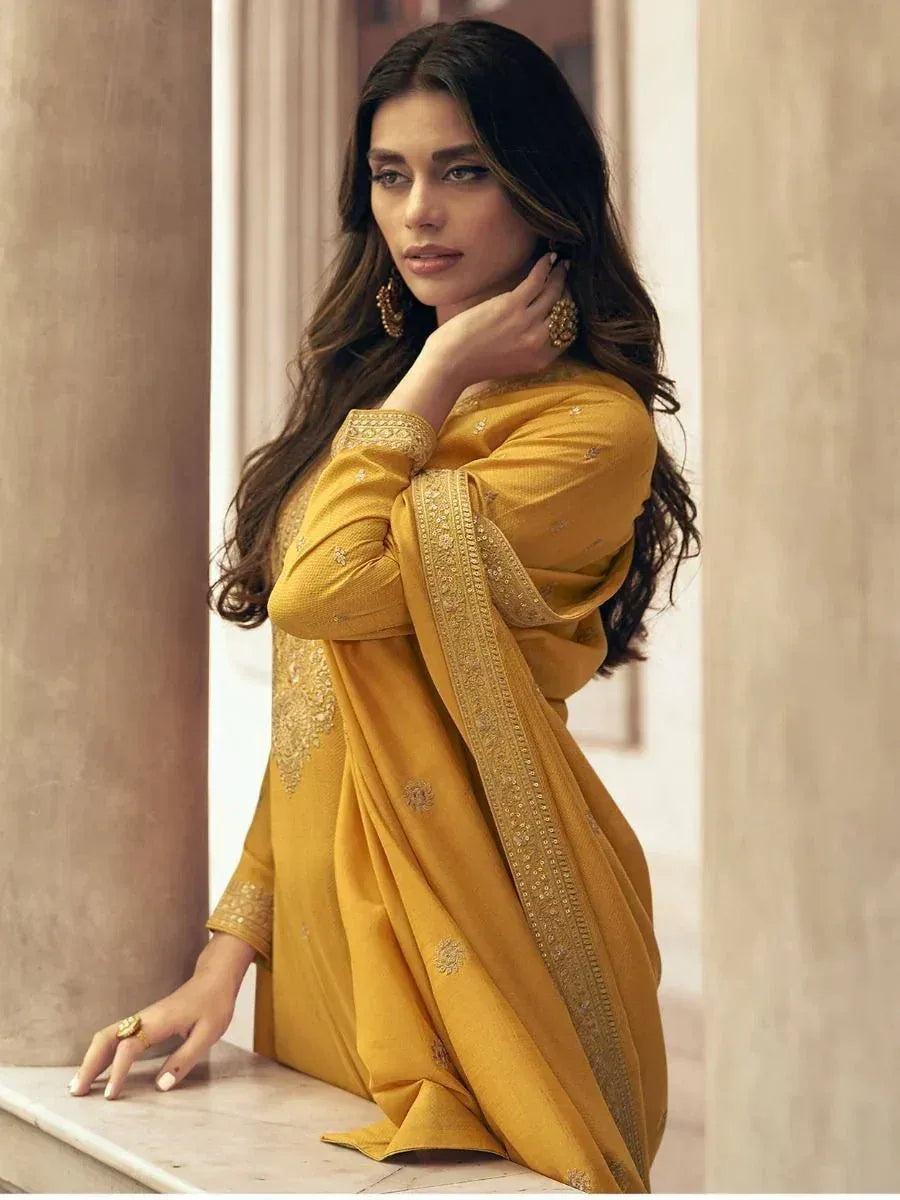 Yellow embroidered salwar kameez with gold detailing, perfect for ethnic occasions