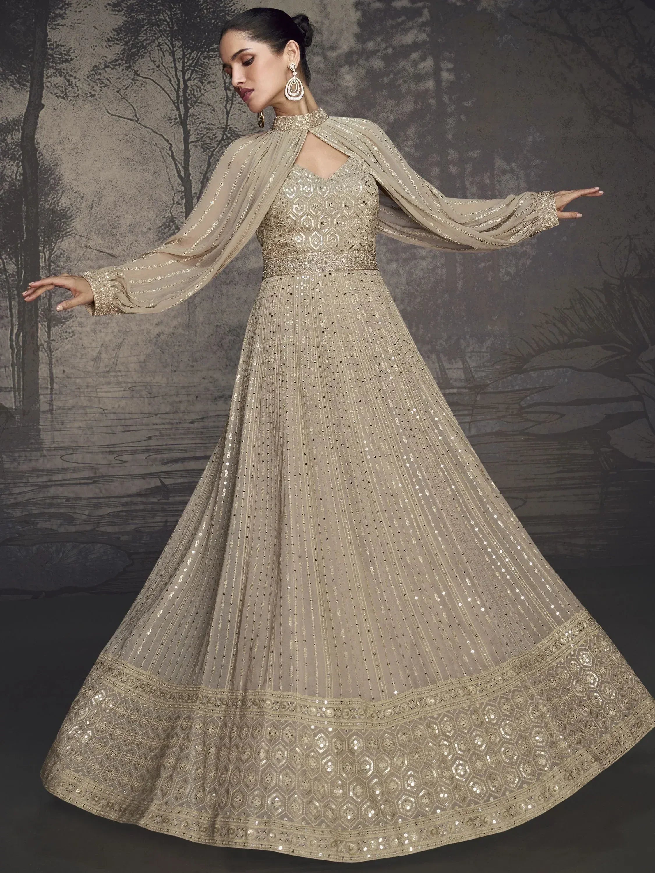 Elegant beige embroidered anarkali gown with cape sleeves, perfect for Indian ethnic wear events