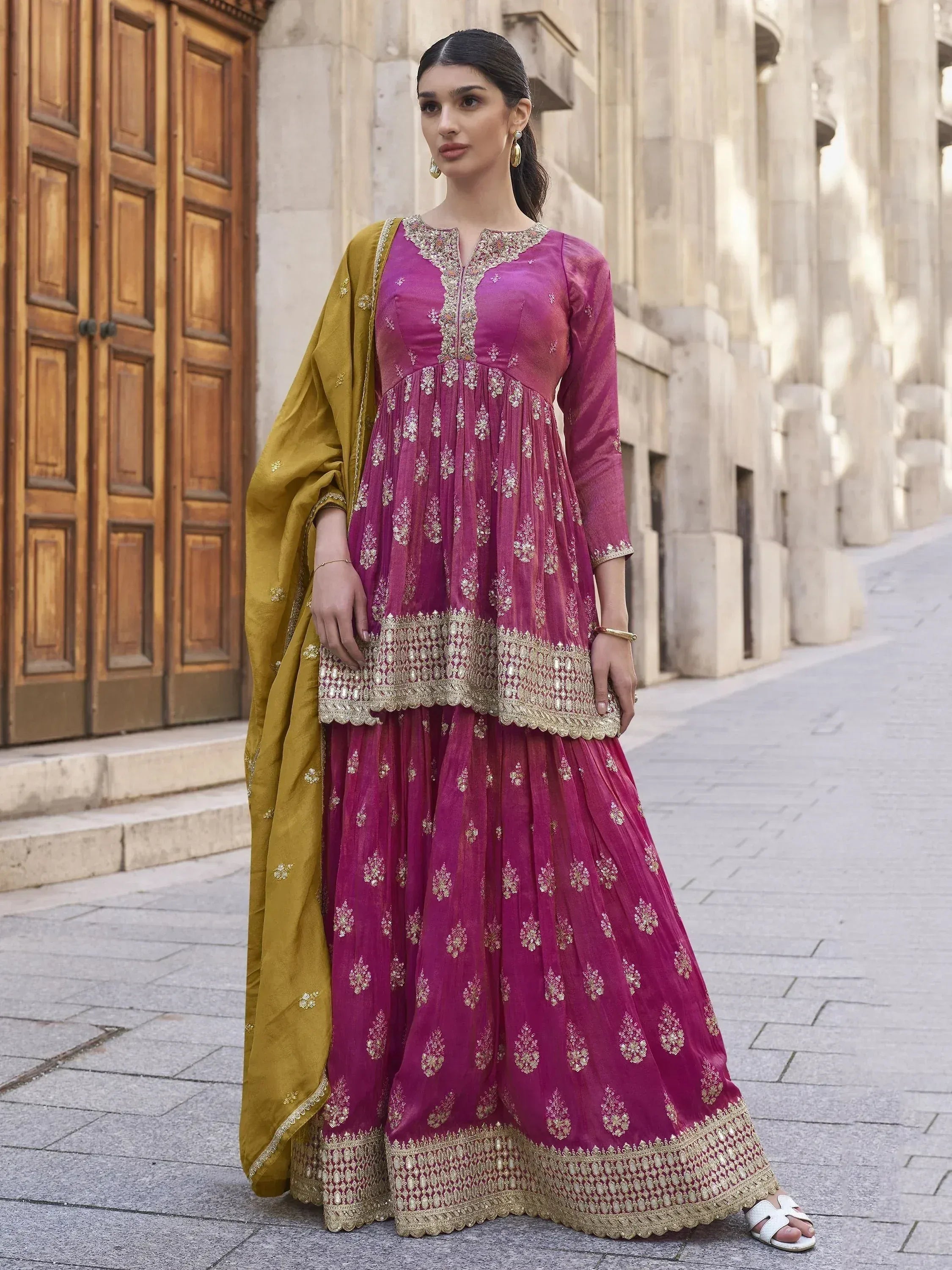 Elegant magenta anarkali with gold embroidery and mustard dupatta, perfect for Indian ethnic occasions.