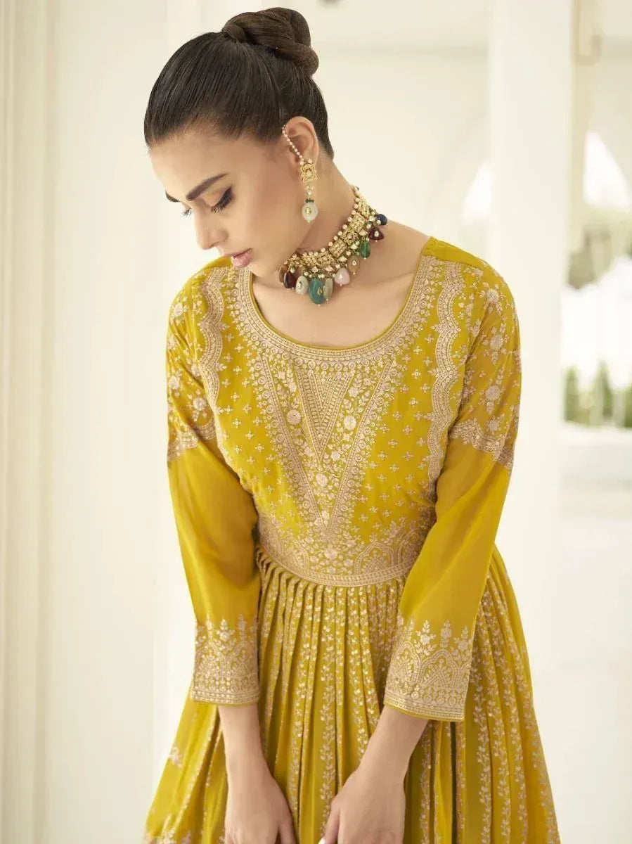 Woman in mustard yellow embroidered ethnic gown with statement choker necklace