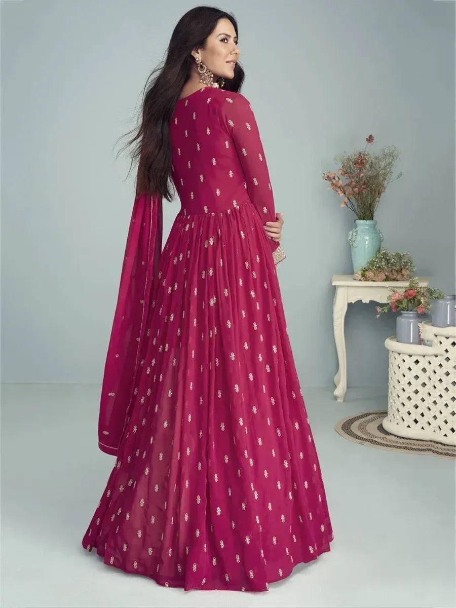 Woman in maroon embroidered anarkali gown with sheer sleeves, ethnic Indian wear