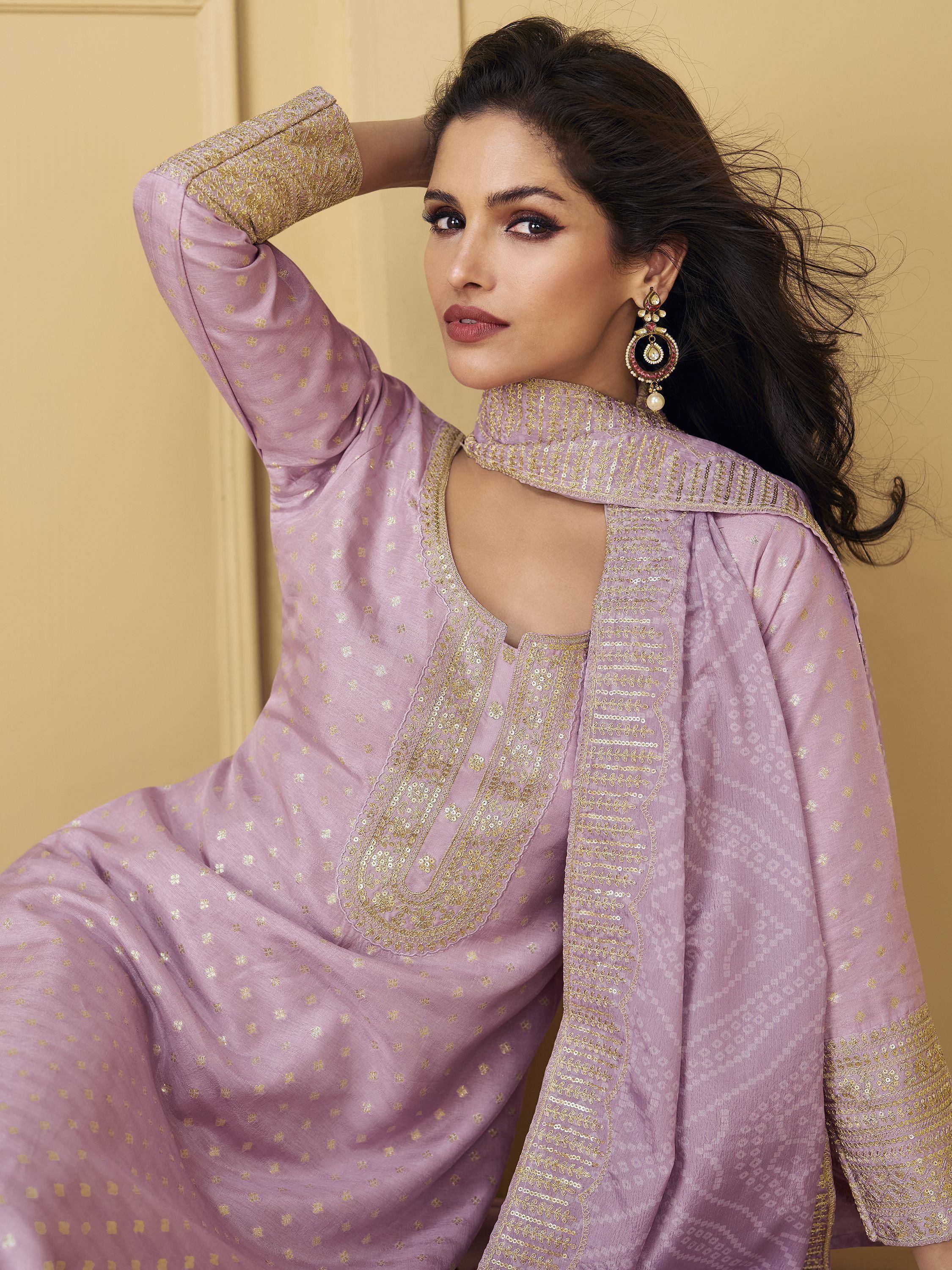 Elegant lavender ethnic kurta with gold embroidery and sequins, paired with statement earrings for festive occasions.