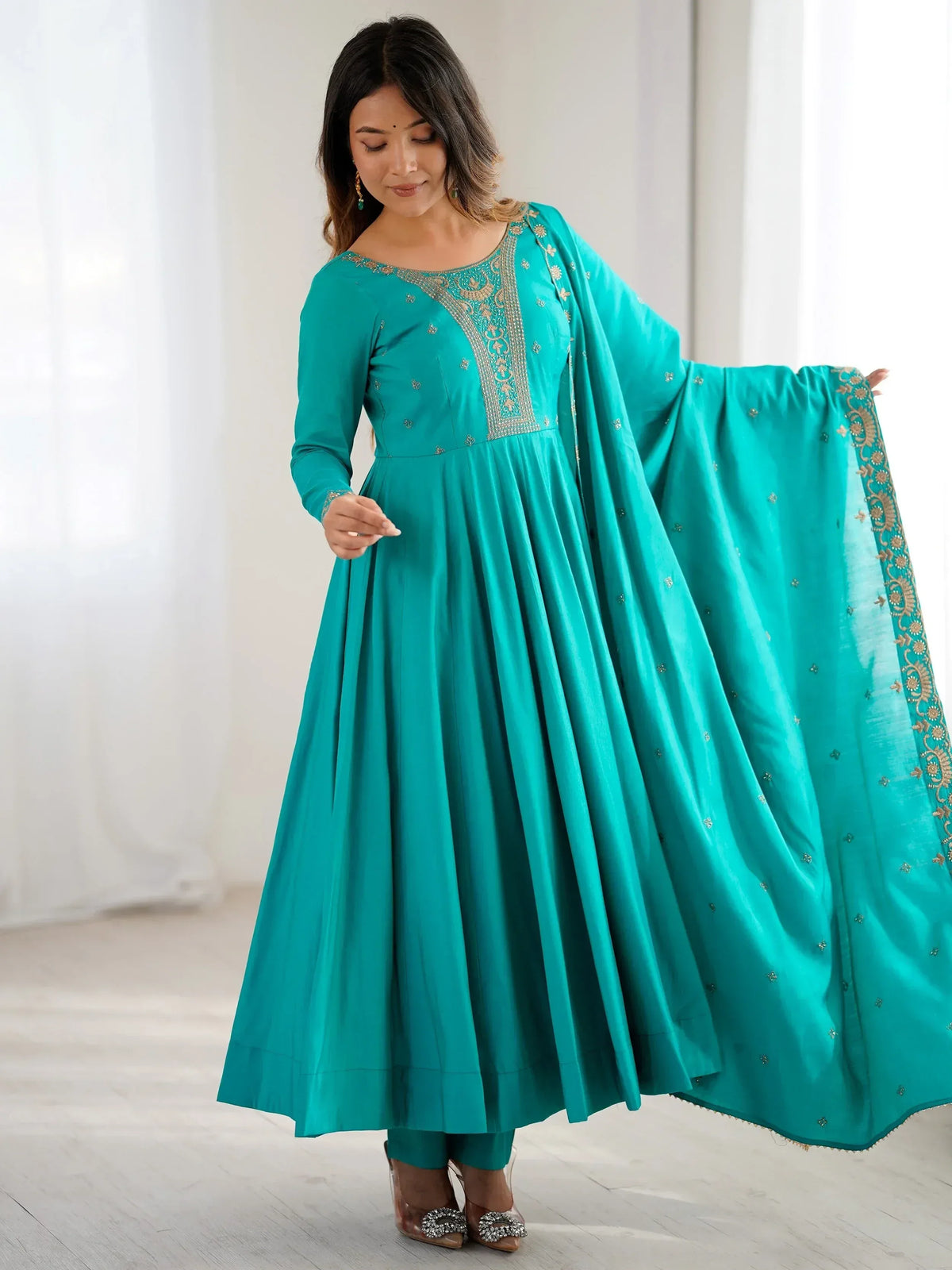 Teal ethnic gown with gold embroidery and matching dupatta for Indian wear