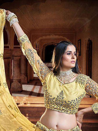 Elegant yellow designer lehenga choli with intricate embroidery, perfect for Indian ethnic wear occasions.