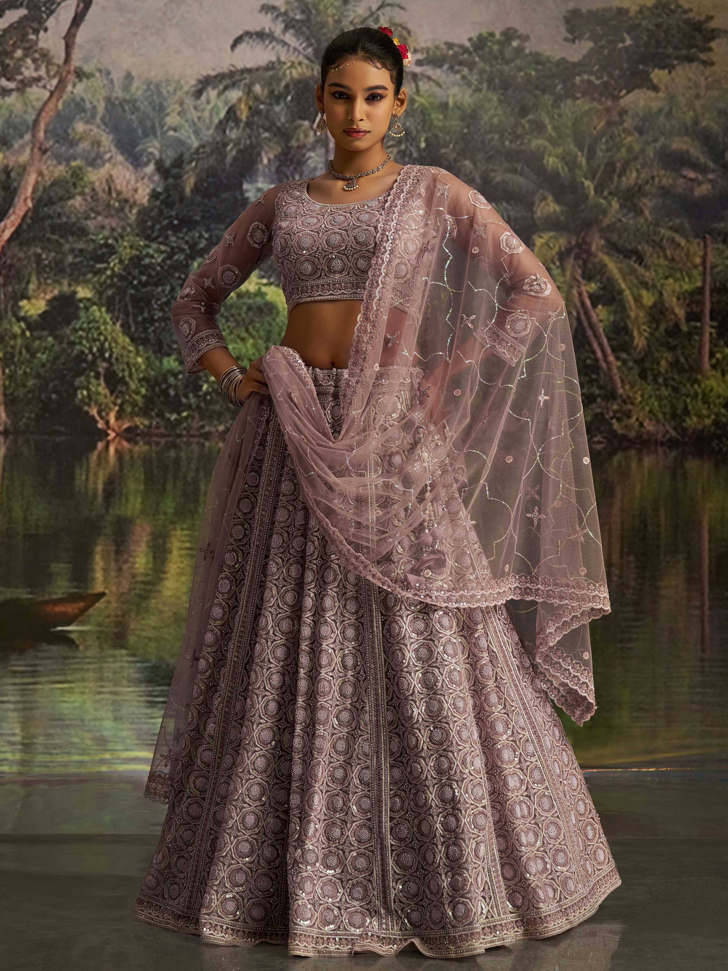 Elegant mauve lehenga choli with intricate embroidery and sheer dupatta, perfect for Indian ethnic occasions