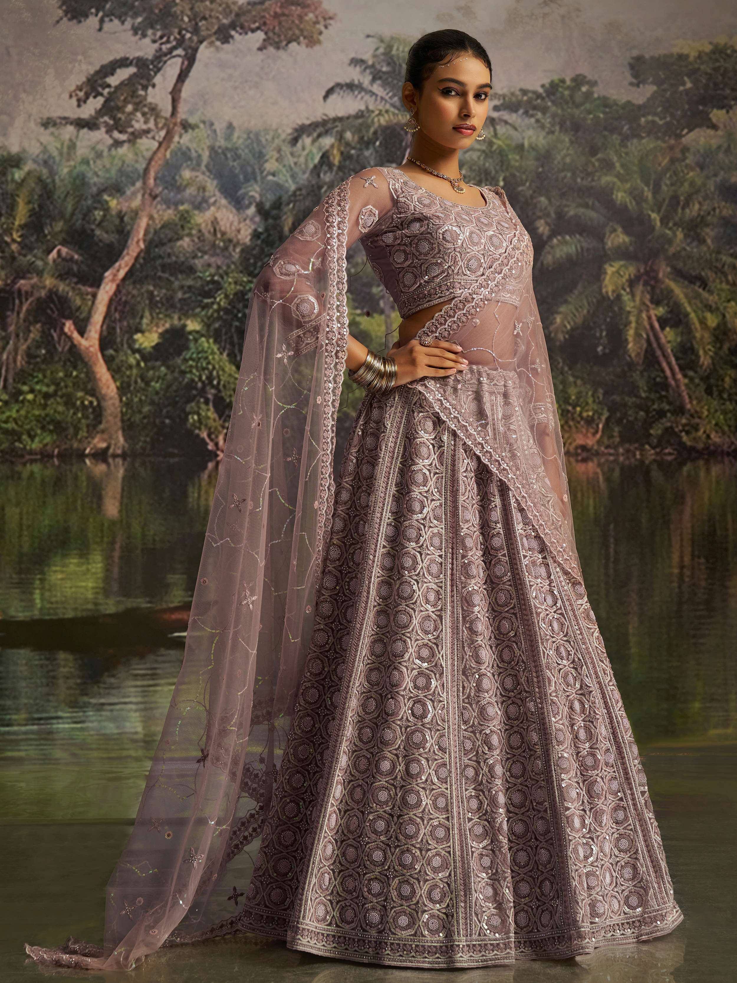 Elegant mauve designer lehenga choli with intricate embroidery and sheer cape, perfect for Indian ethnic wear.
