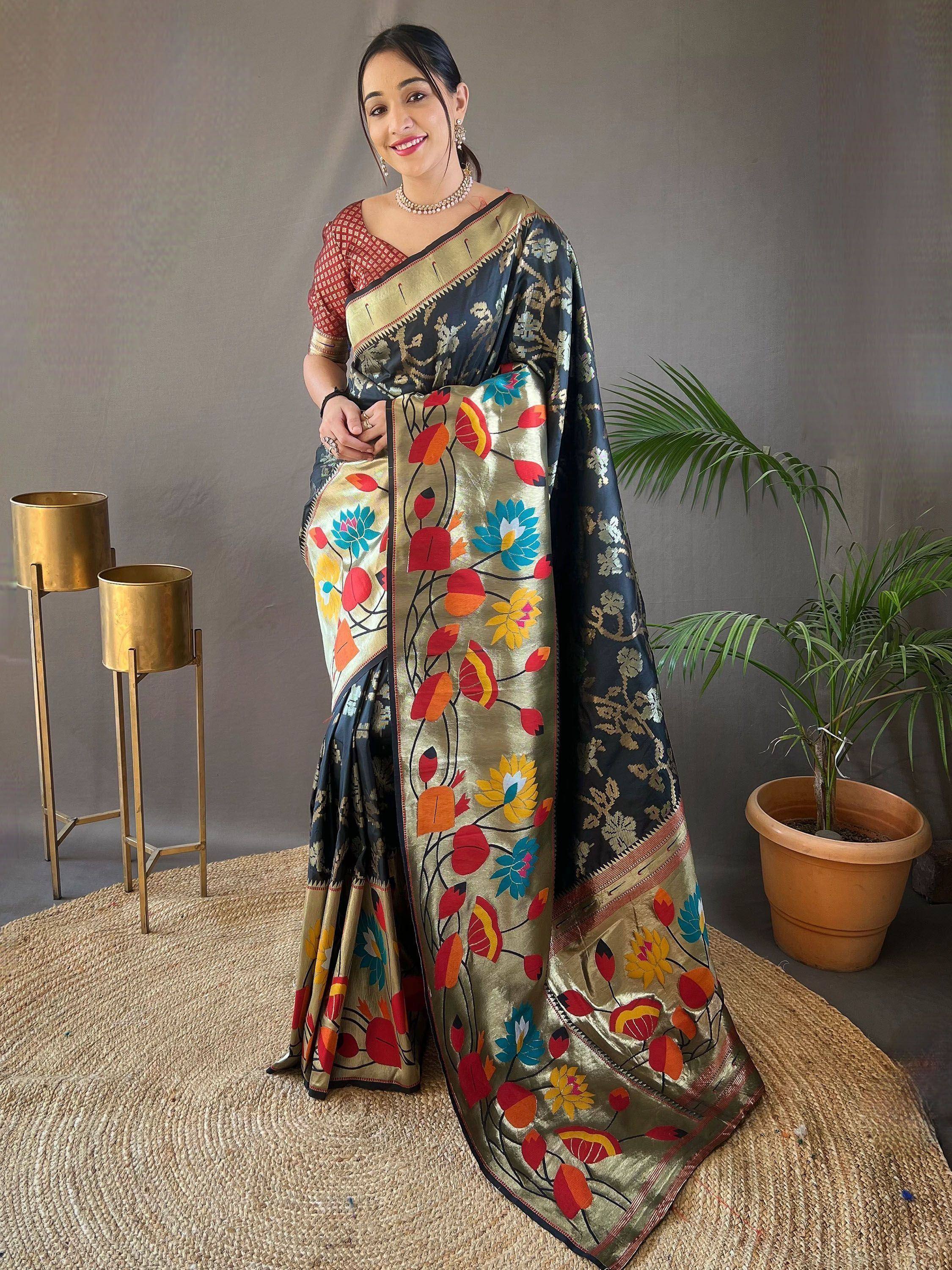 Elegant black and gold saree with vibrant floral embroidery, paired with a red blouse, perfect for ethnic occasions.