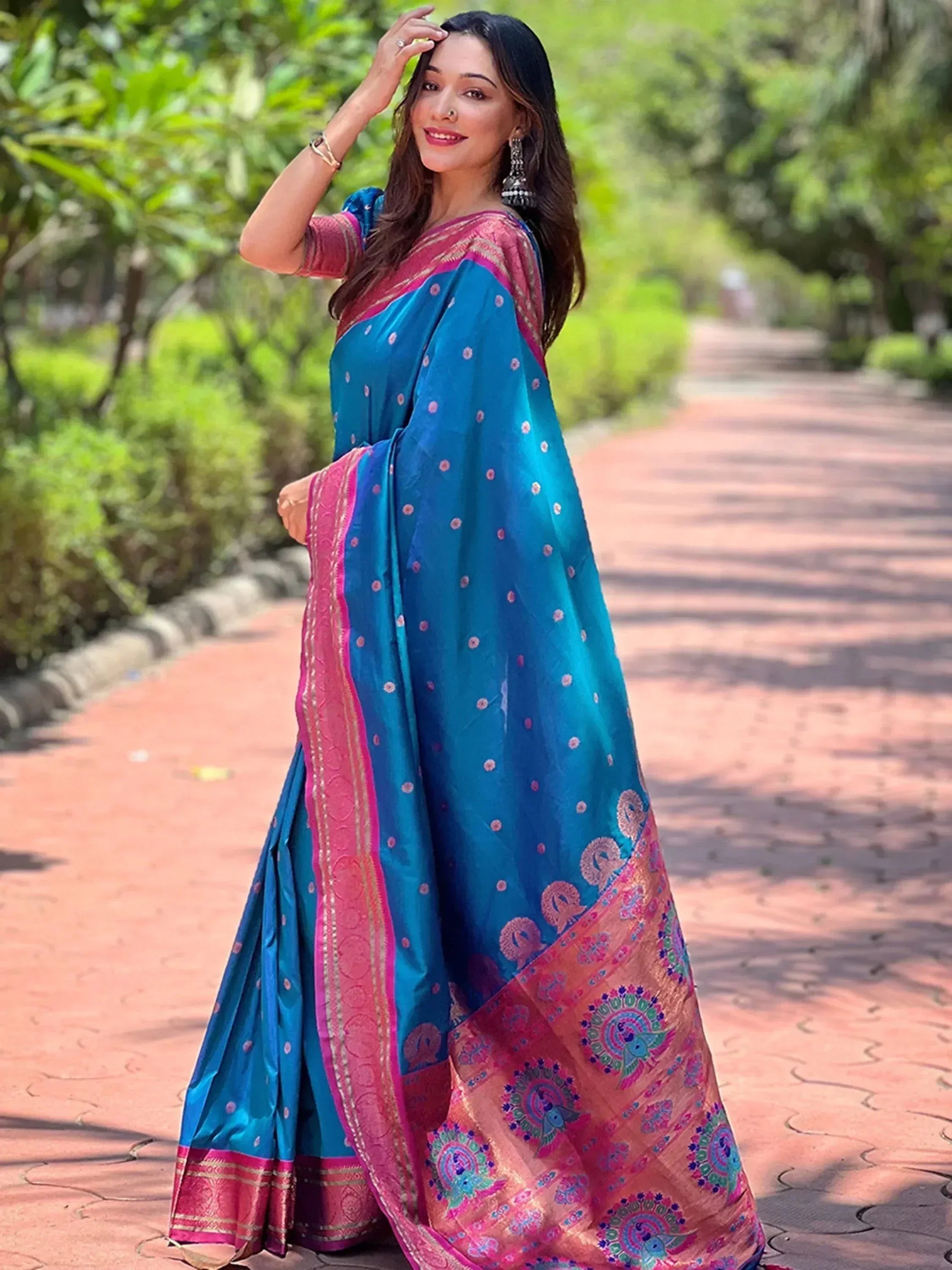 Woman in blue and pink ethnic saree with peacock print, perfect for Indian occasions
