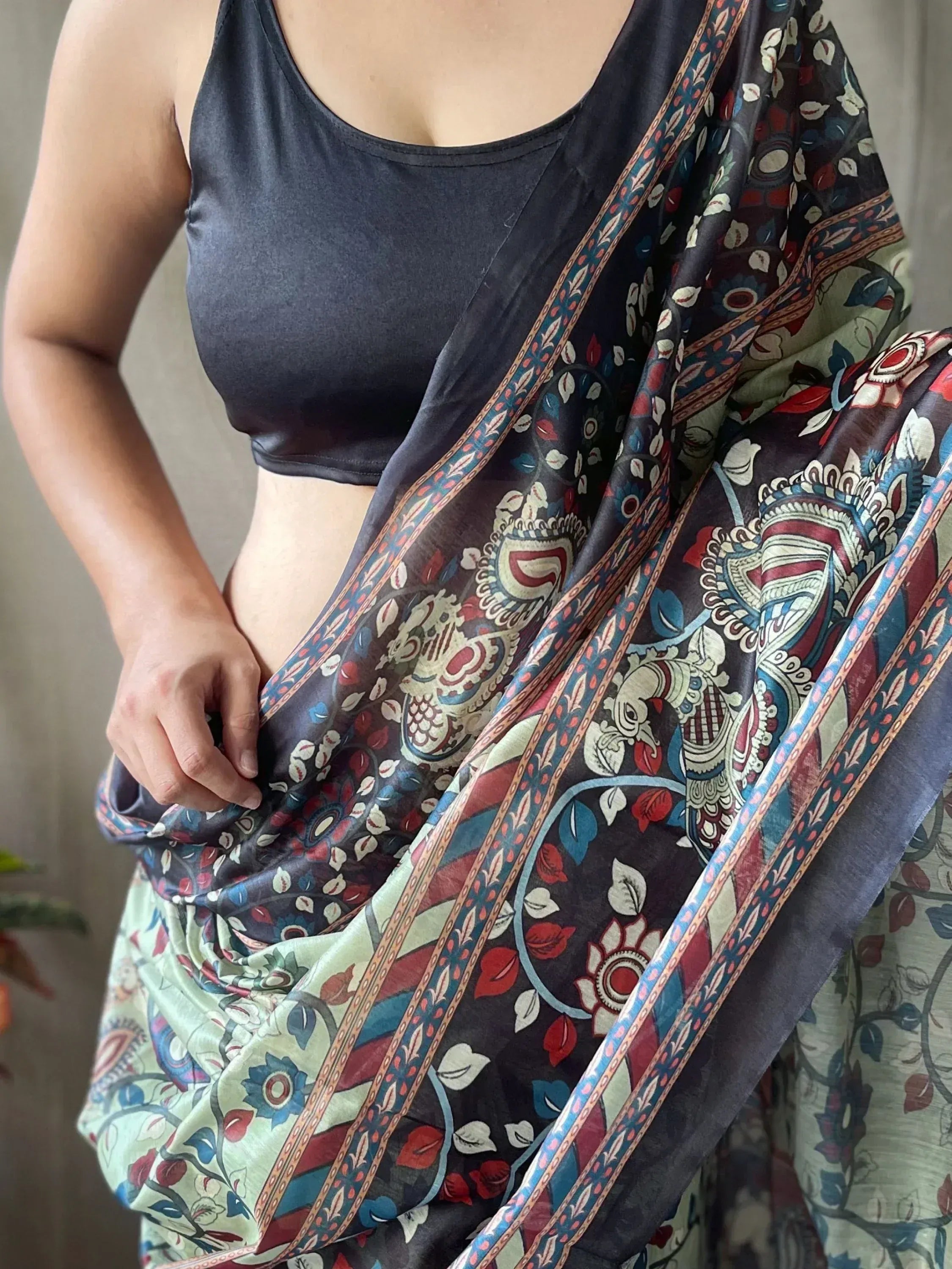 Woman wearing printed ethnic saree with peacock design and black blouse, Indian traditional wear