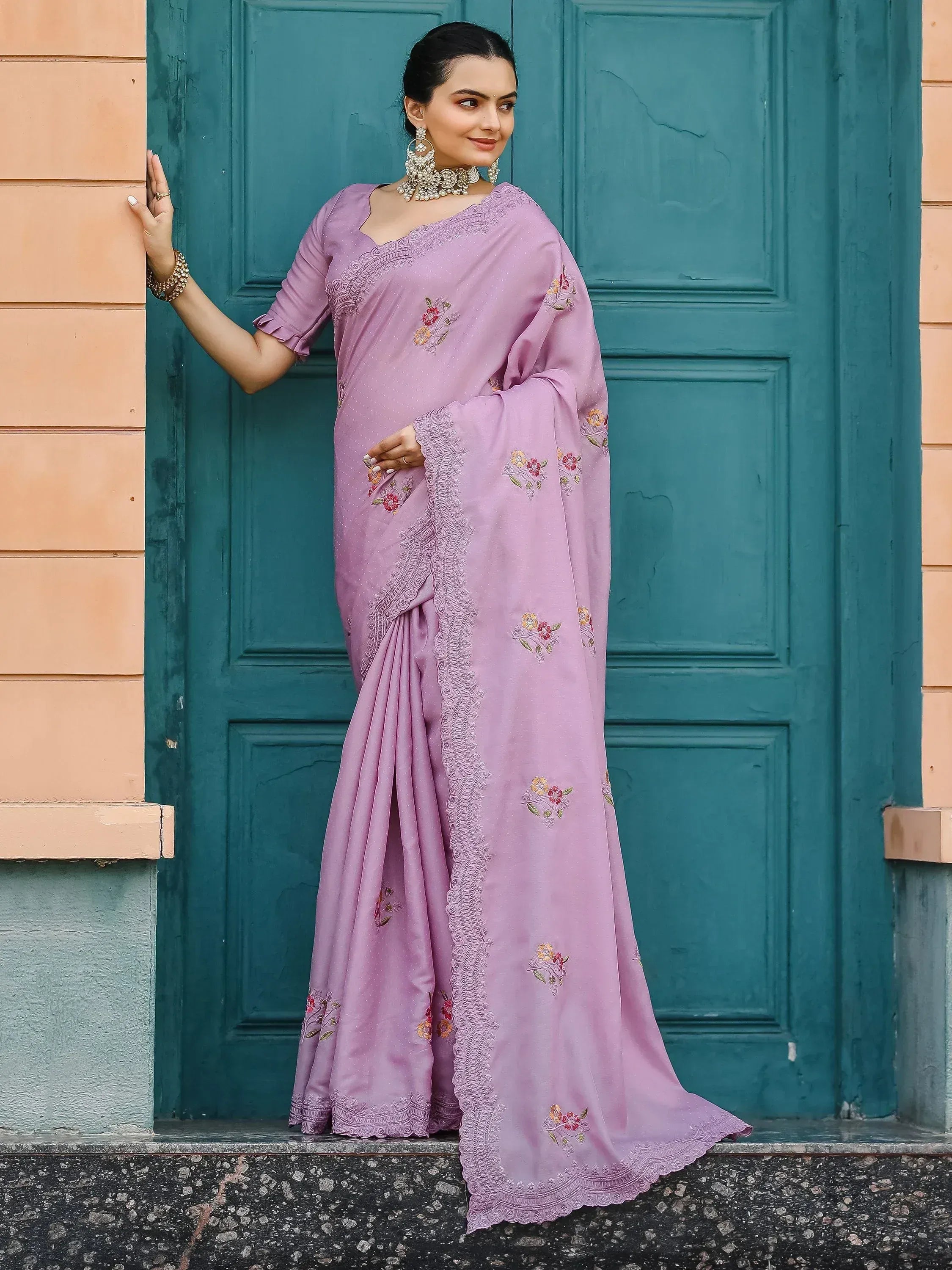Lavender saree with floral embroidery and lace border, styled with ethnic jewelry for Indian occasions