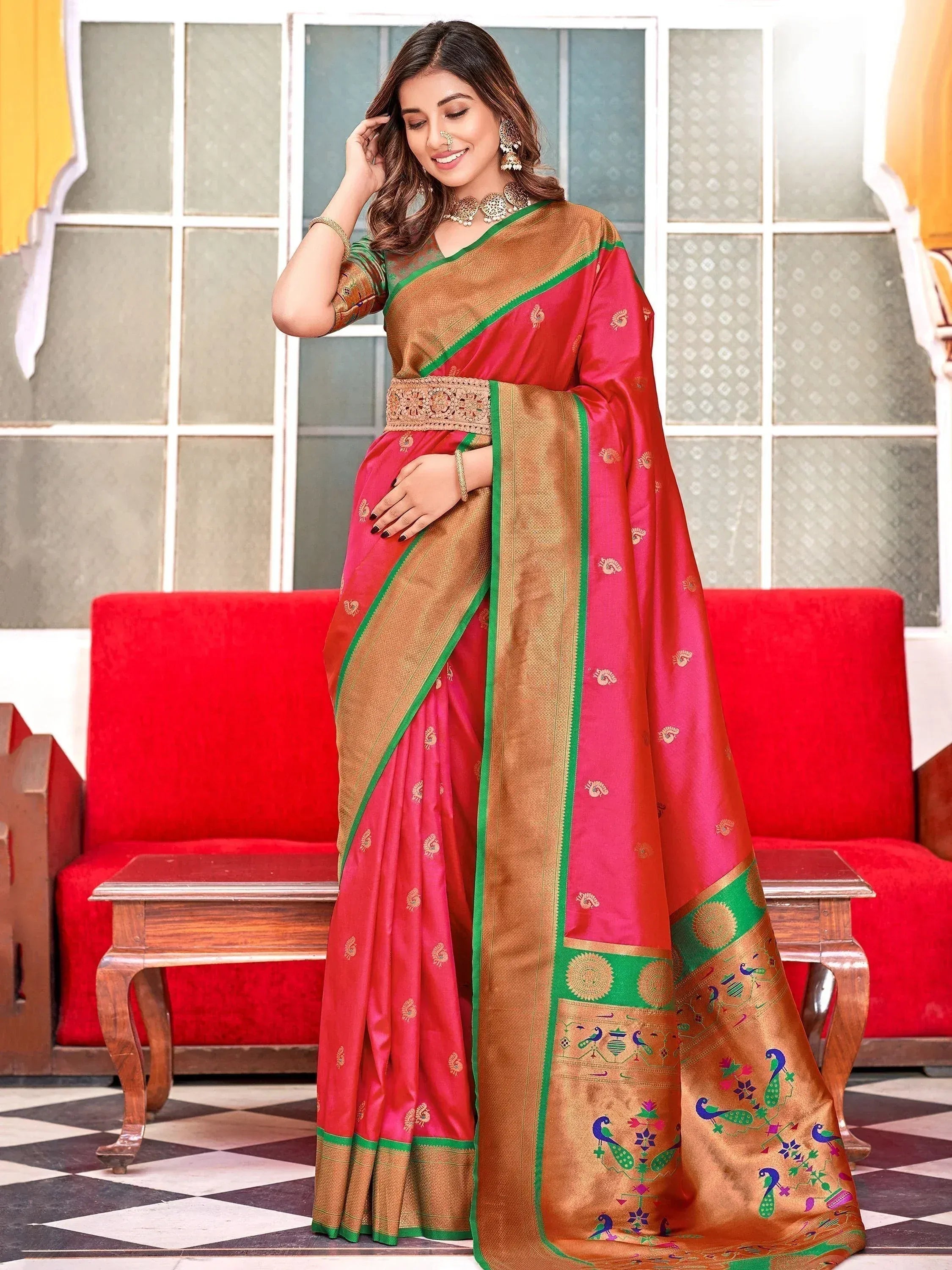 Woman in vibrant pink and gold ethnic saree with peacock motifs, perfect for Indian celebrations