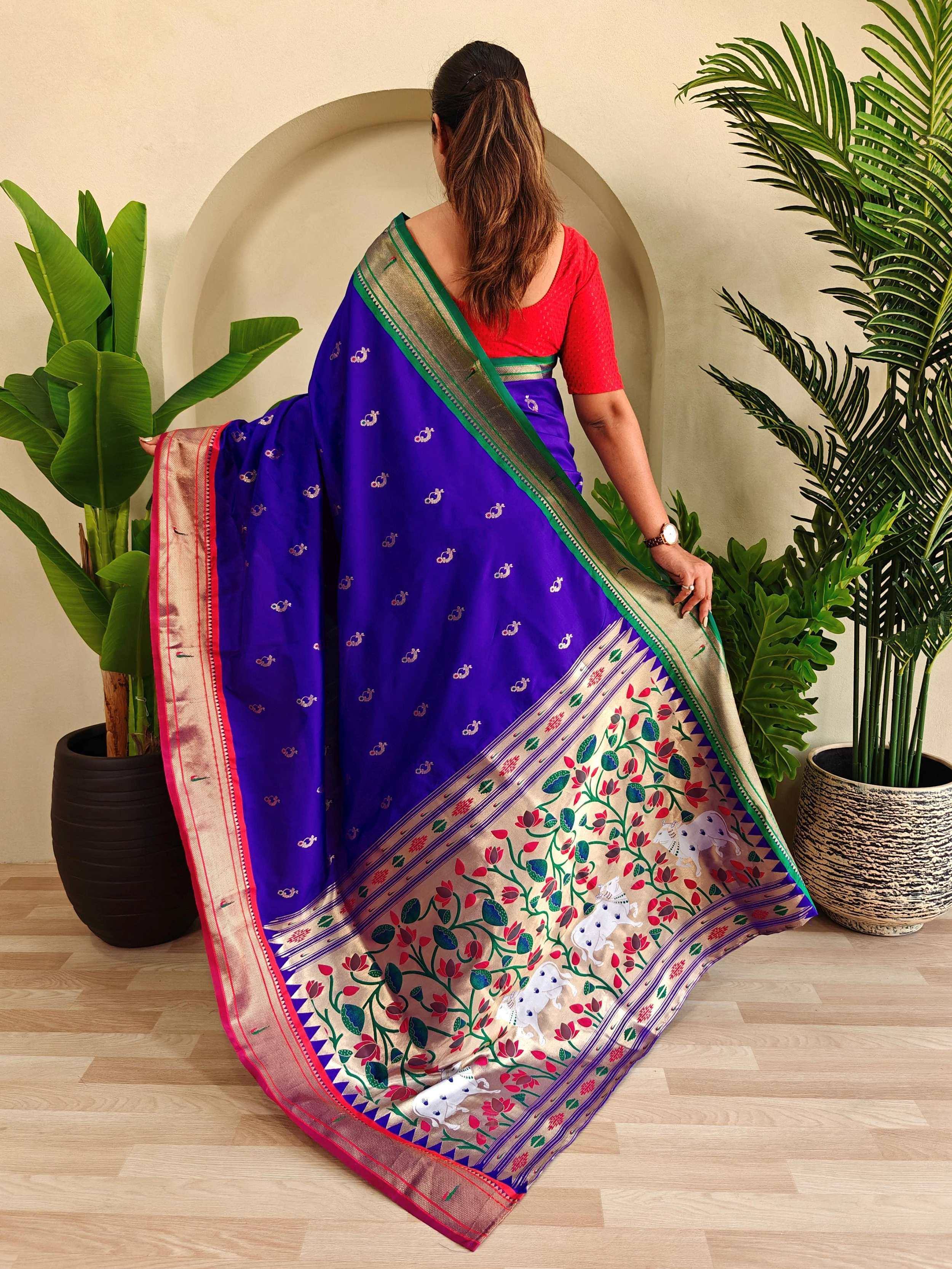 Purple designer saree with floral and elephant motifs, paired with red blouse, ideal for Indian ethnic wear