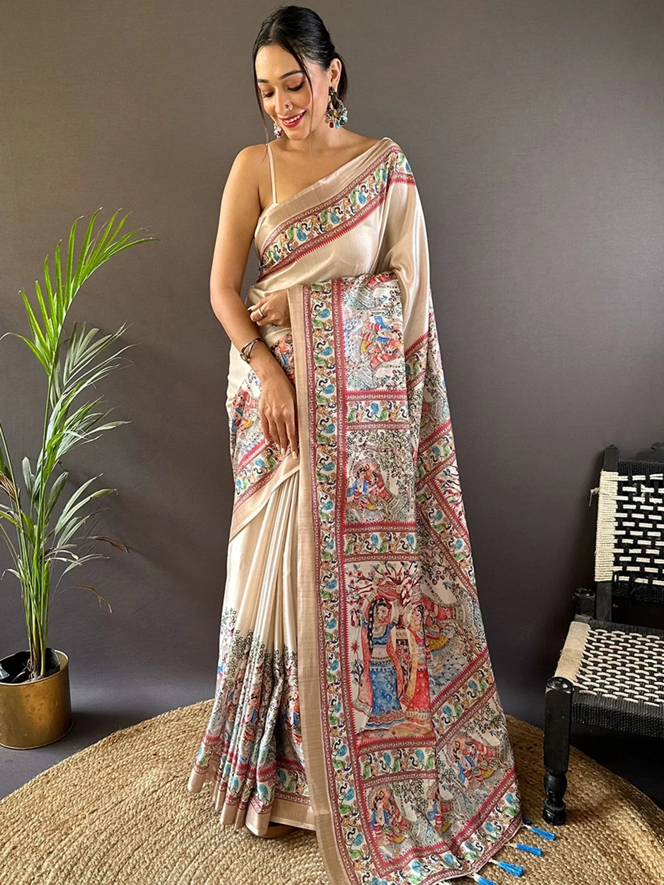 Woman in elegant beige saree with colorful traditional print, perfect for ethnic occasions